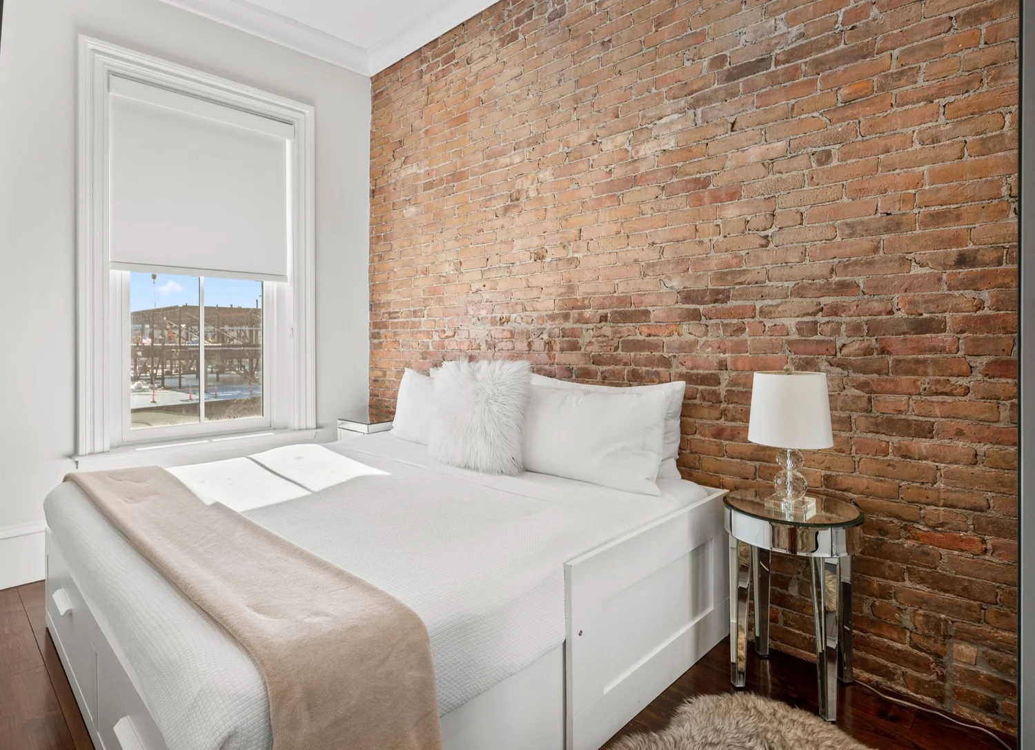 Bedroom with exposed brick wall