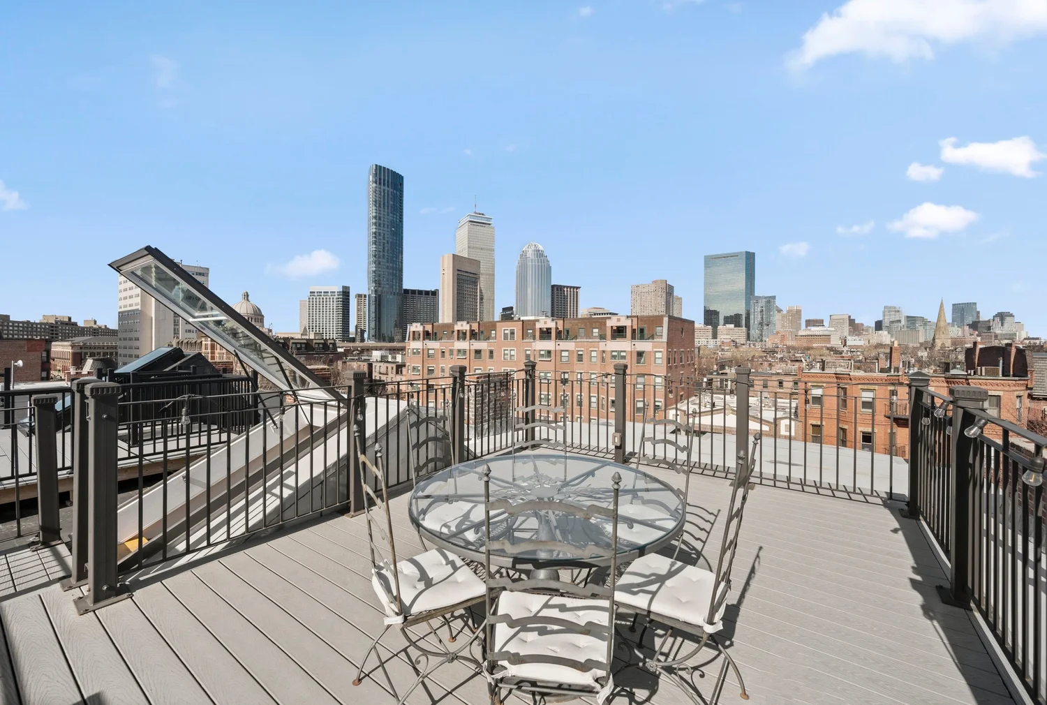Private roof deck with outdoor dining and Boston skyline views
