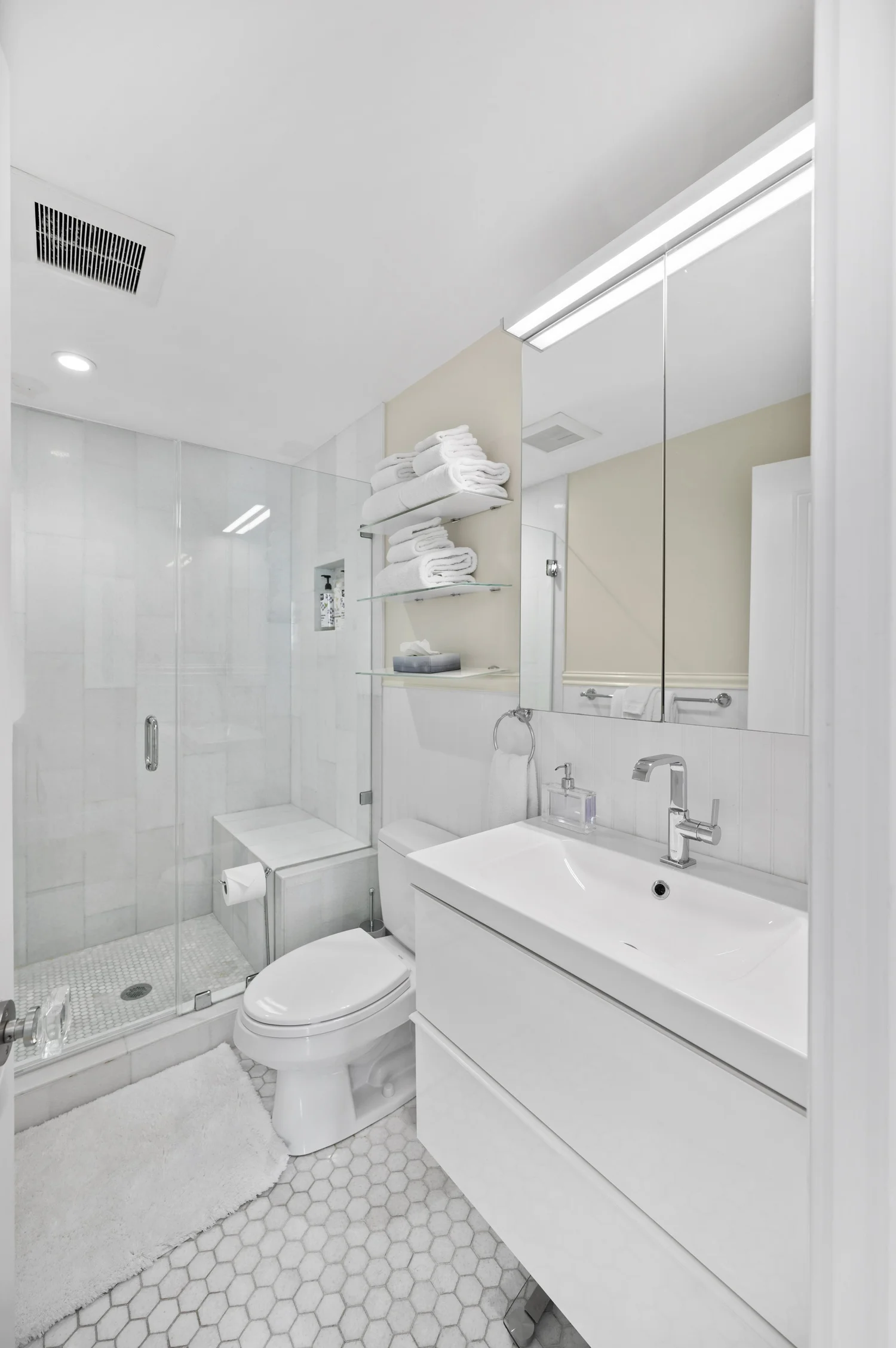 Marble walk-in shower and modern vanity