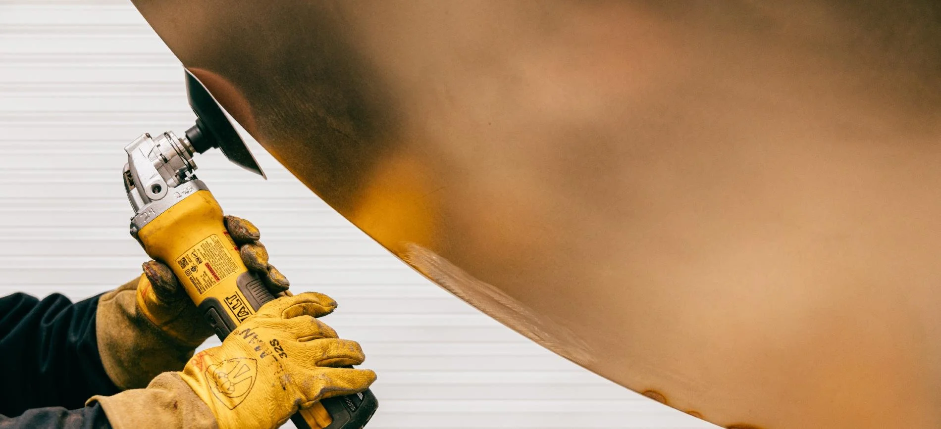 Brass sheet being sanded