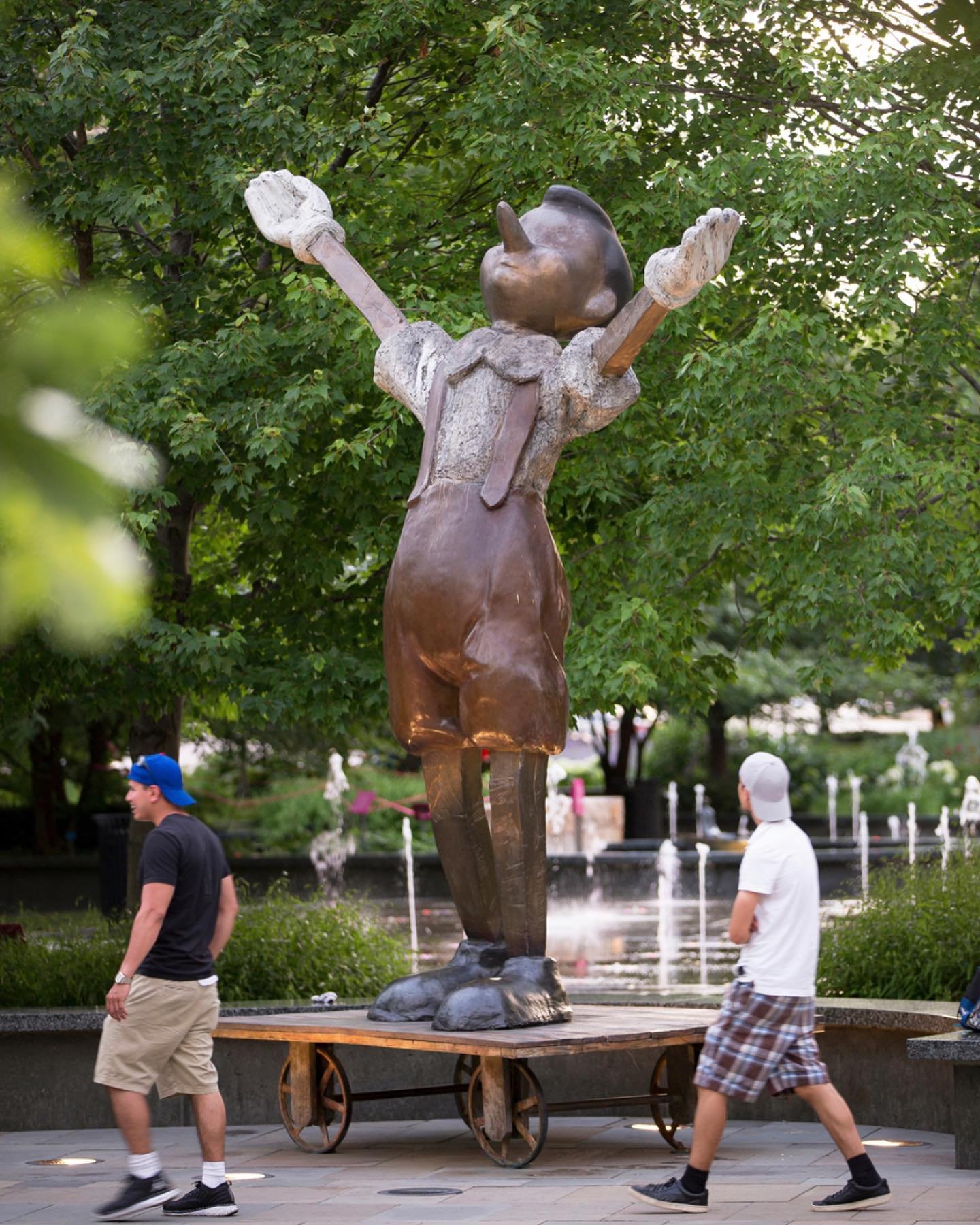Standing atop a flat bronze cart with four wheels, Pinocchio proclaims his boyhood with outstretched arms in the sculpture Big White Gloves, Big Four Wheels, 2009 @jimdinestudio 

The 10-foot, pointy-nosed fellow has been reinstalled facing Ninth Str