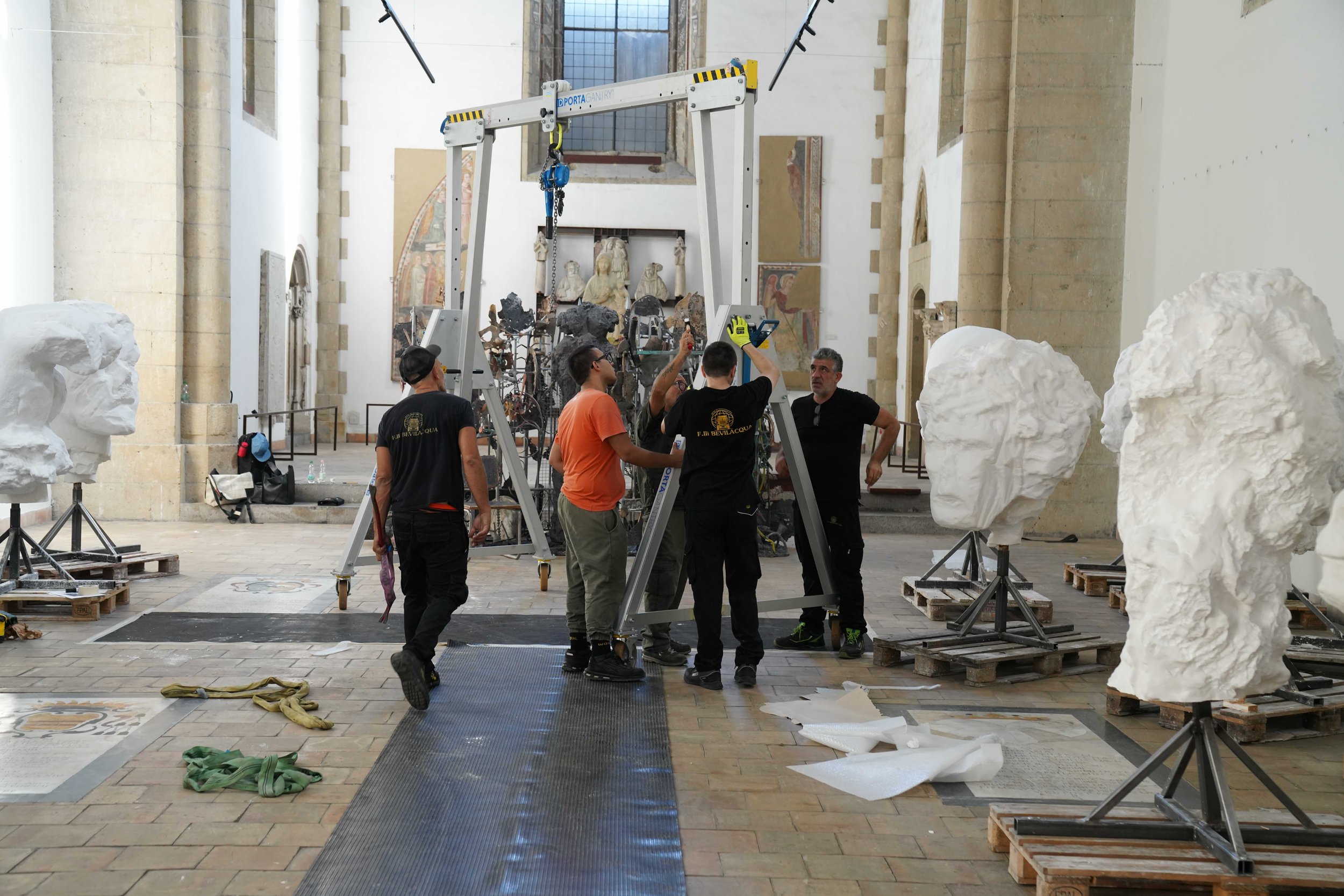 Images of workers installing Images of Jim Dine's plaster heads in his new exhibition Elysian Fields