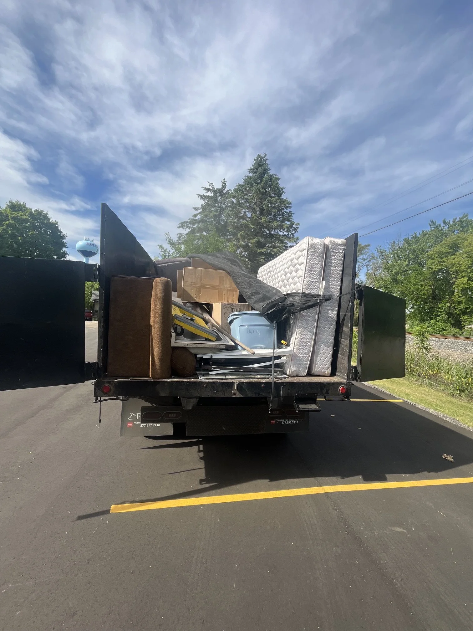 248-Junk-Be-Gone Truck loaded from property management cleanout in Holly, MI 