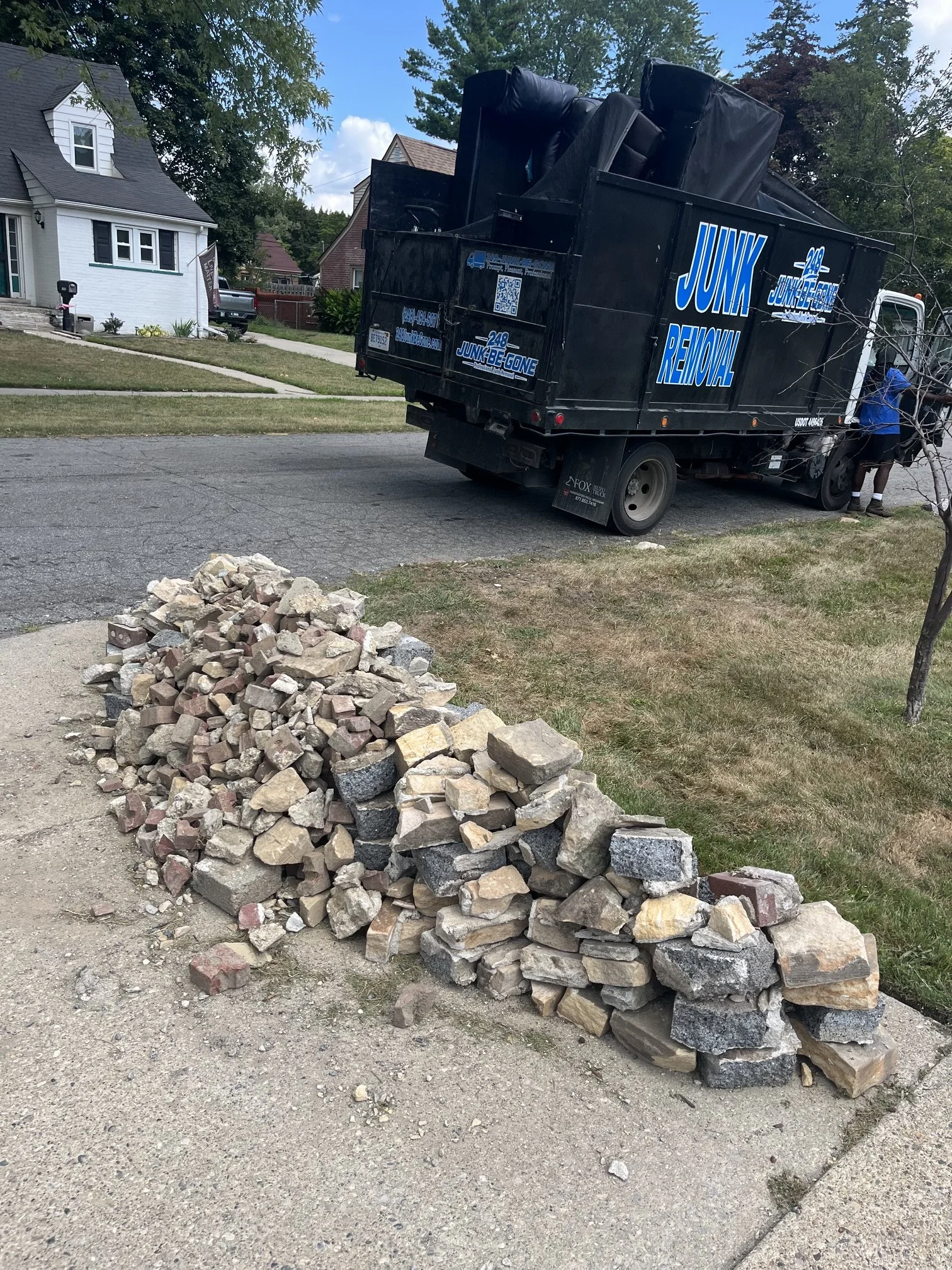 brick/rock removal with 248-junk-be-gone truck in photo