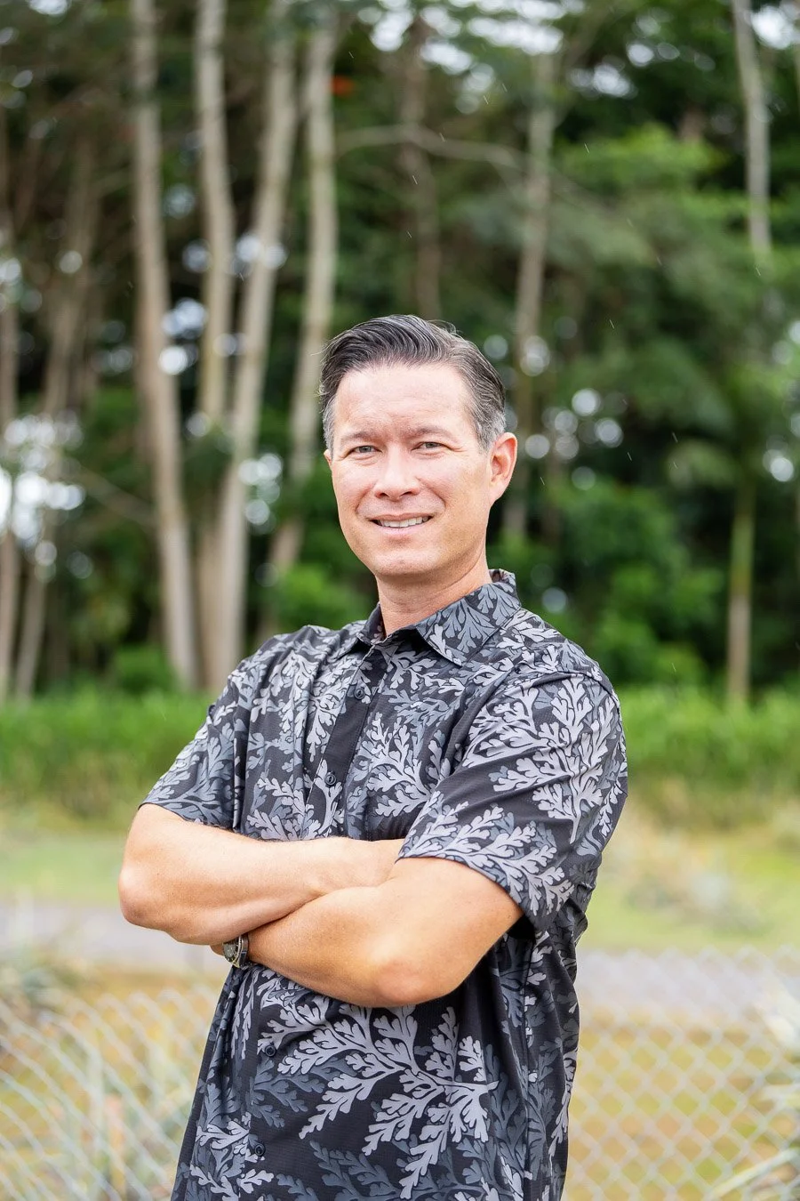 Mountain landscape with a blue lake, grassy hills, and overcast sky.