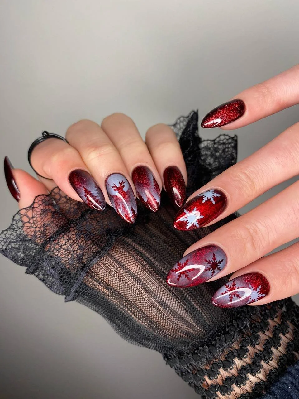 Deep red holiday manicure with soft shimmer detail