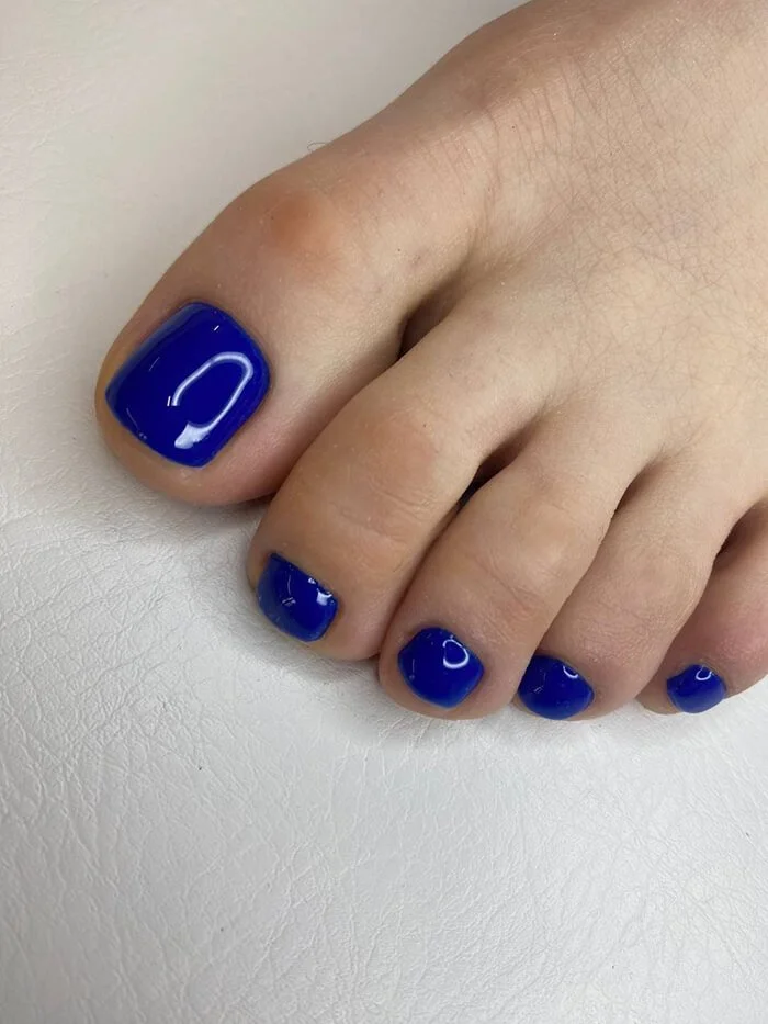 Artistic gel pedicure design with metallic elements – professional toenail styling in NYC nail salon