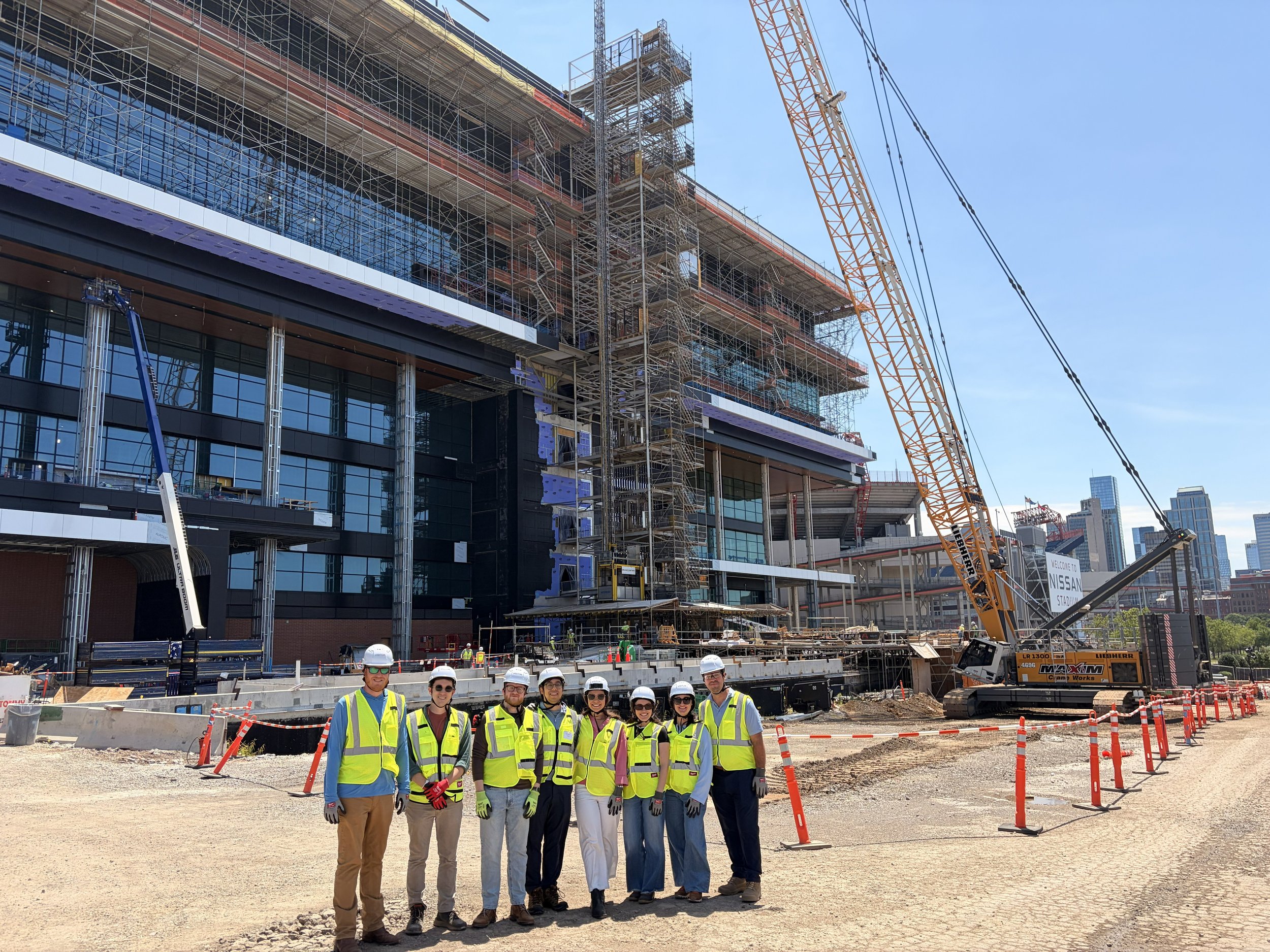 A group of tnAchieves staff members stand in front of the new Titans stadium