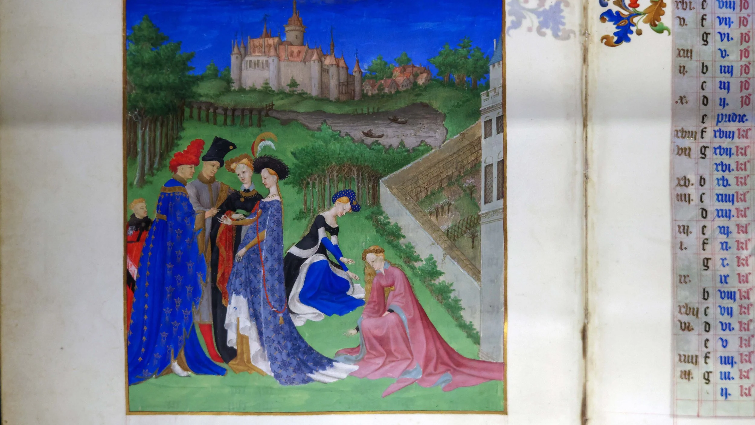 nobles gather in a grassy field for a wedding with a castle behind them