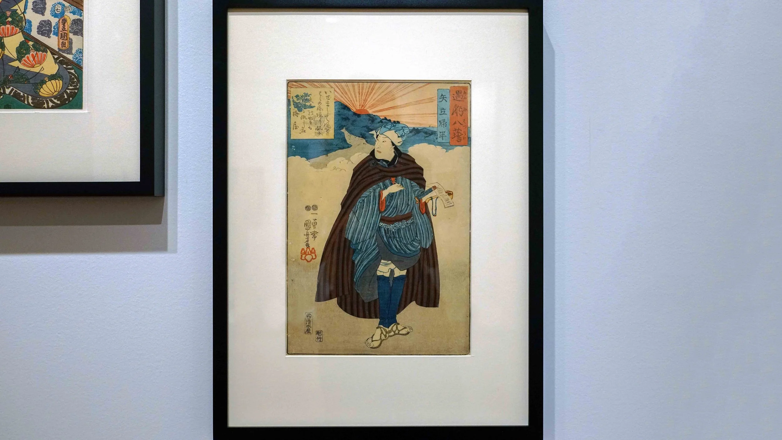 Kabuki actor in full costume with the sun rising in the distance
