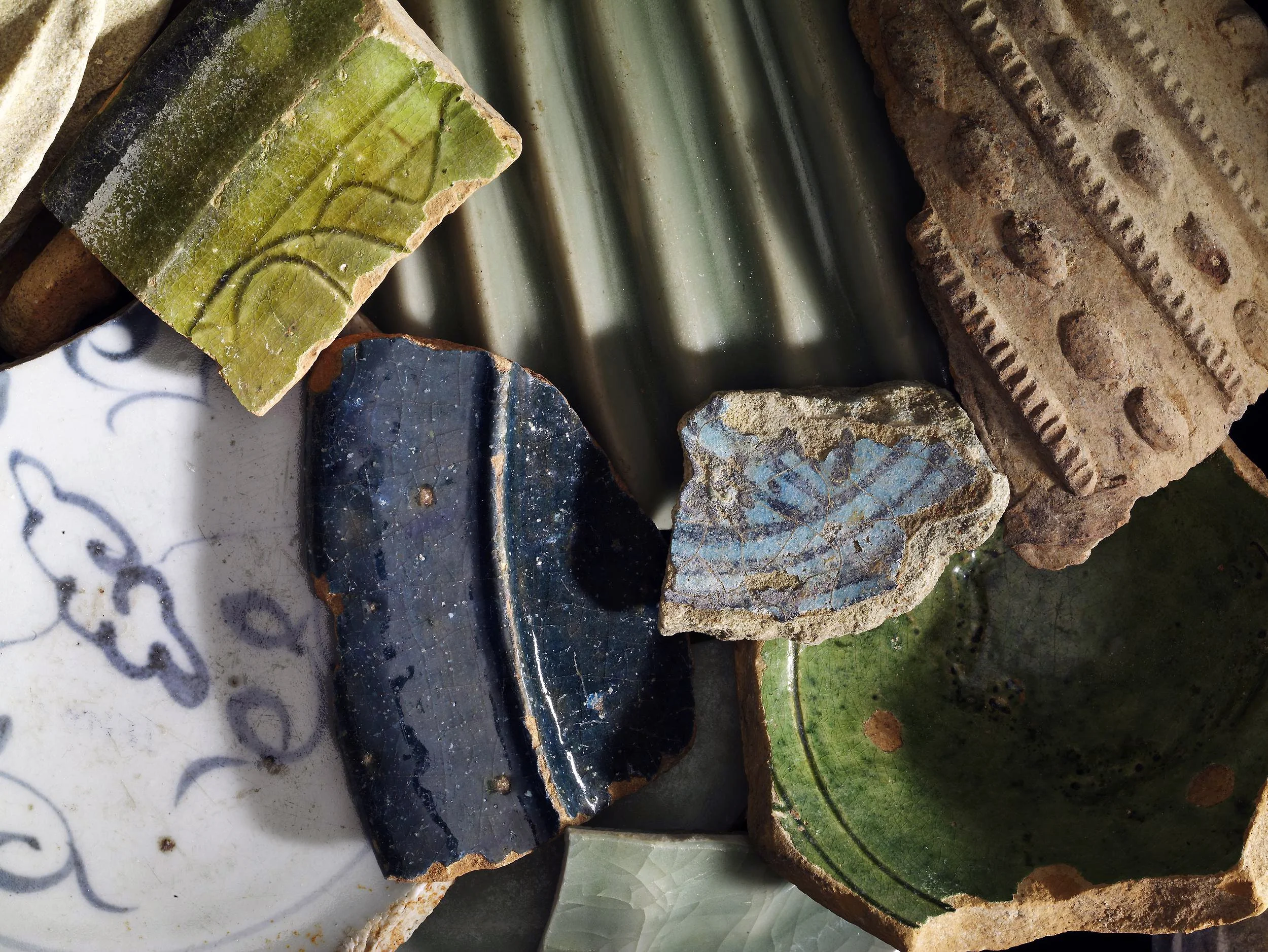 various colored pieces of broken pottery