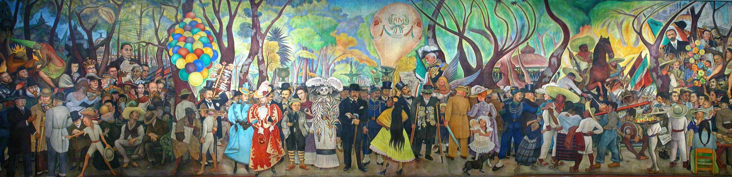 Colorful mural depicting a Mexican cultural celebration with people in traditional clothing, balloons, and festive activities in a park setting.