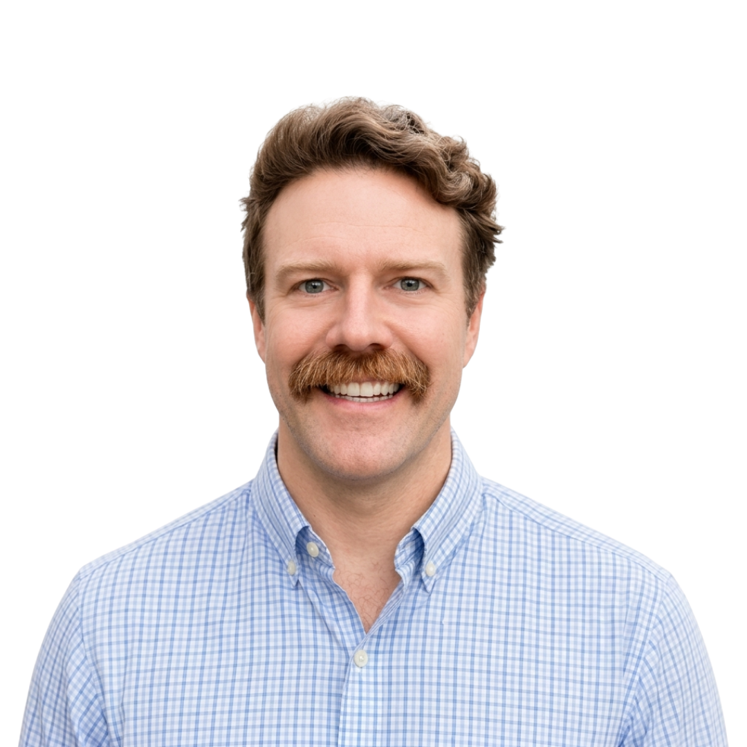 Black and white portrait of a smiling man with short hair.