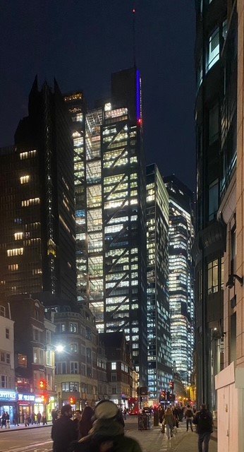 A view down Bishopsgate at night showing the full occupancy of the high-rise office towers in the City of London, post-Covid.
