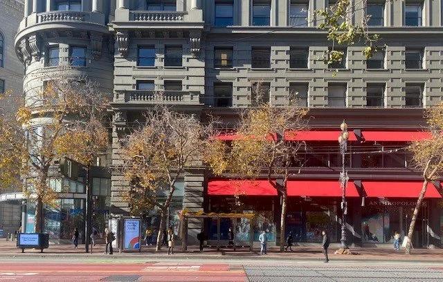 New storefronts and awnings animate the facade and return the building to its original state.