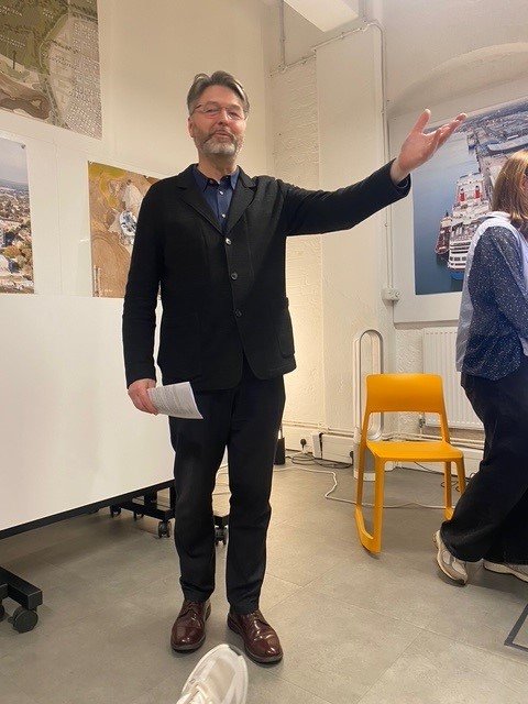 Jonathan Rose of Prior + Partners giving a presentation of his firm's work at Thamesmead and Silvertown along the Thames Estuary.
