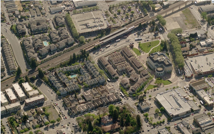 Aerial view looking west showing the new City Hall and residential development in place of surface parking around the BART station.