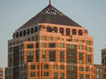 The pyramidal roof recalls the Masonic symbol on the Dollar Bill. 