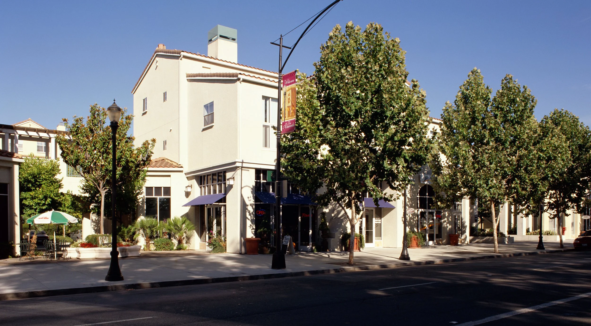 A new infill mixed-use project with ground floor street-fronted retail, rear parking, and residential uses above.