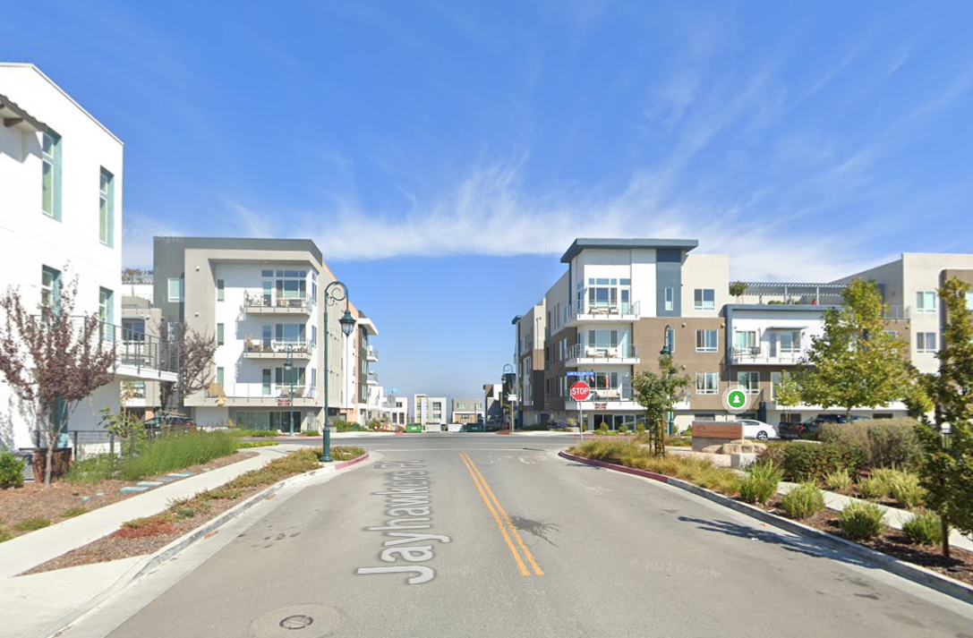 Street view showing three and four-story apartment buildings by different architects.