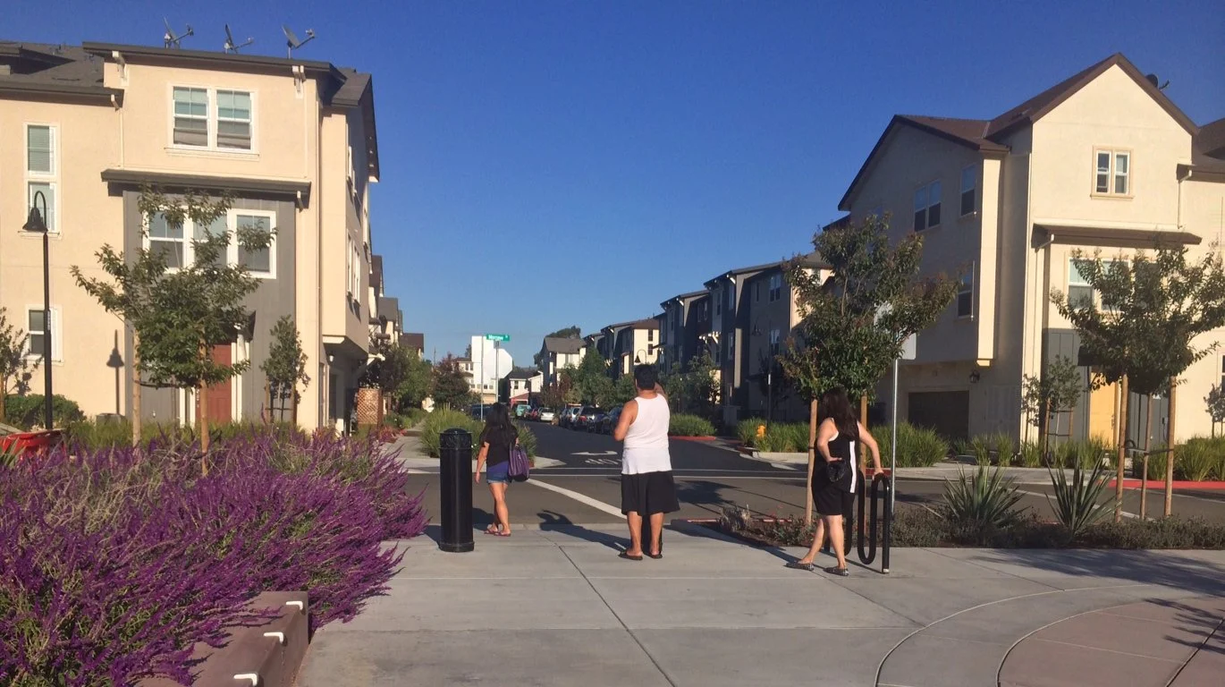View of one of the new residential streets from the park boulevard. 
Architecture by others.