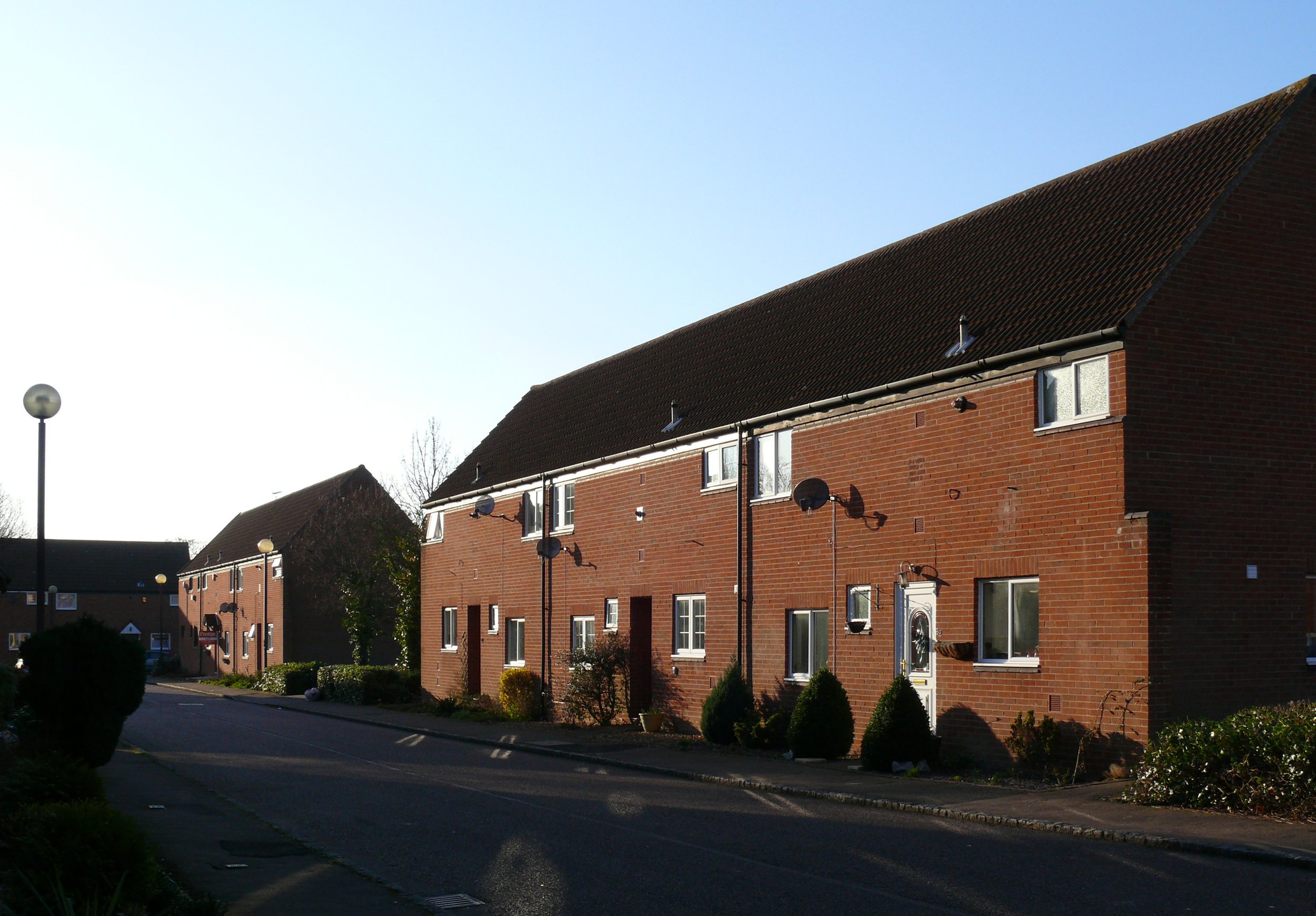 Row houses interspersed with parking courts.