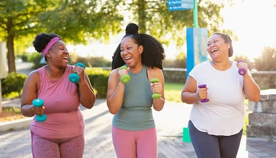 Three women exercising together outdoors, staying active with support from primary care