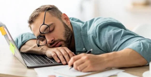 Tired woman with low energy resting her head in her hand