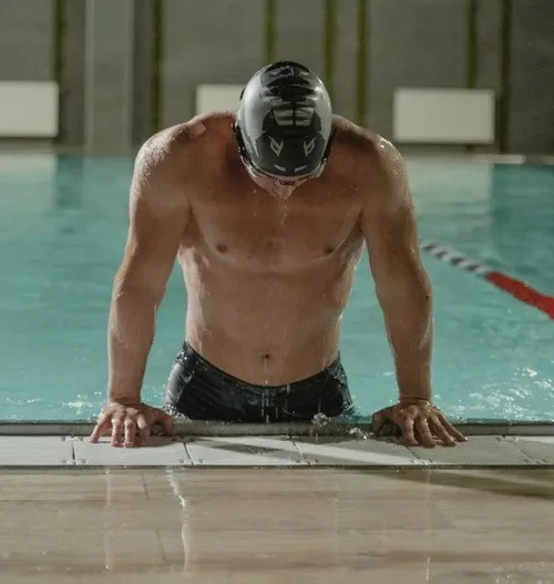 Swimmer resting at the edge of the pool