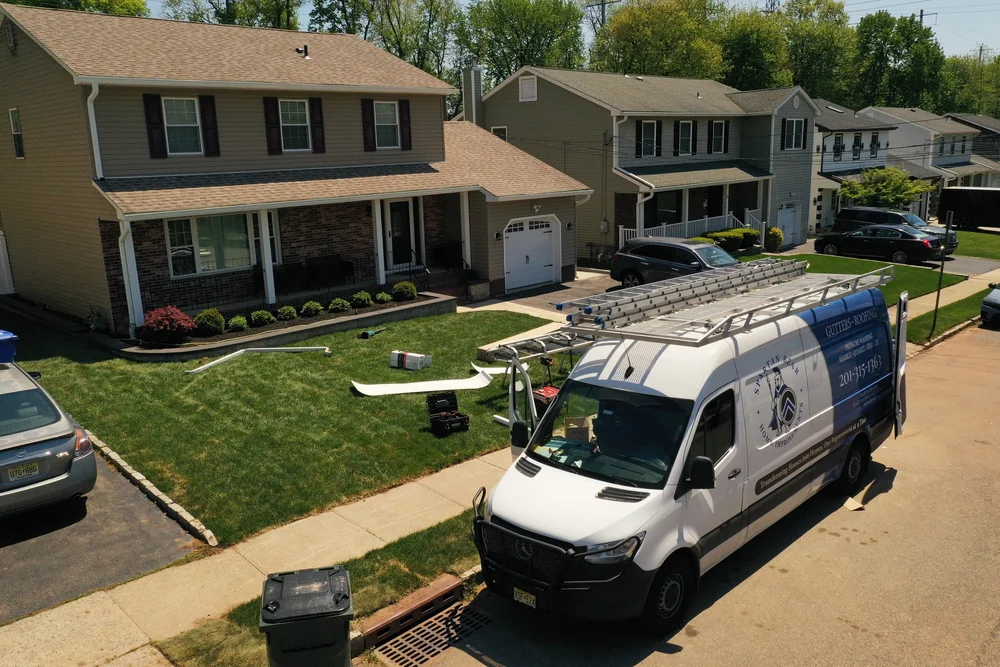 Spartan Bear work van and gutter equipment at a residential project