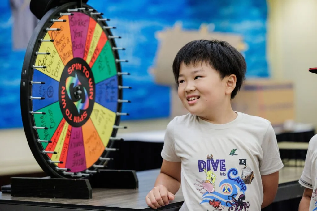 🎶💙 Vote for Camp Kids Are Kids Chicago! 💙🎶
This photo captures one of our favorite camp traditions in motion &mdash; music, laughter, and pure camp spirit all coming together in the most joyful way! From spinning the Wheel of Songs to singing alo