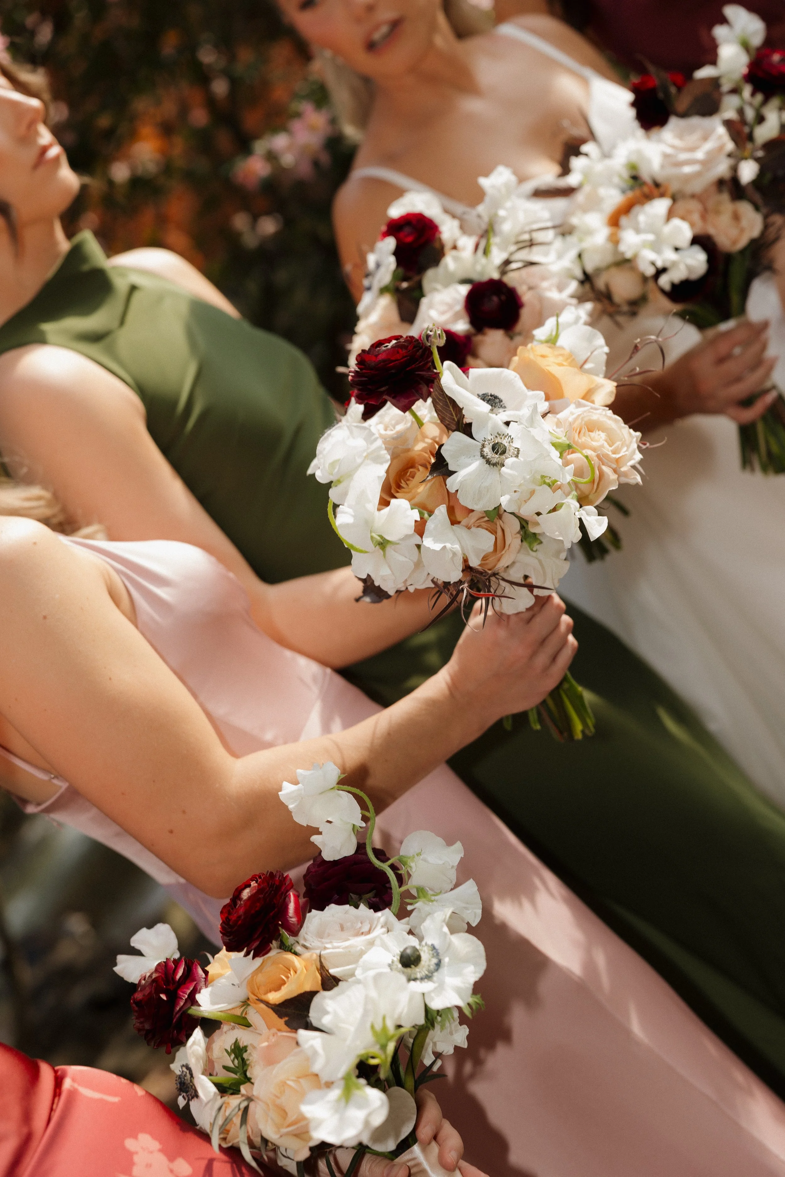 DC Wedding Photographer. Michaela Mae and Co. Women holding bouquets of flowers, likely at a wedding or formal event, with a focus on their hands and floral arrangements.