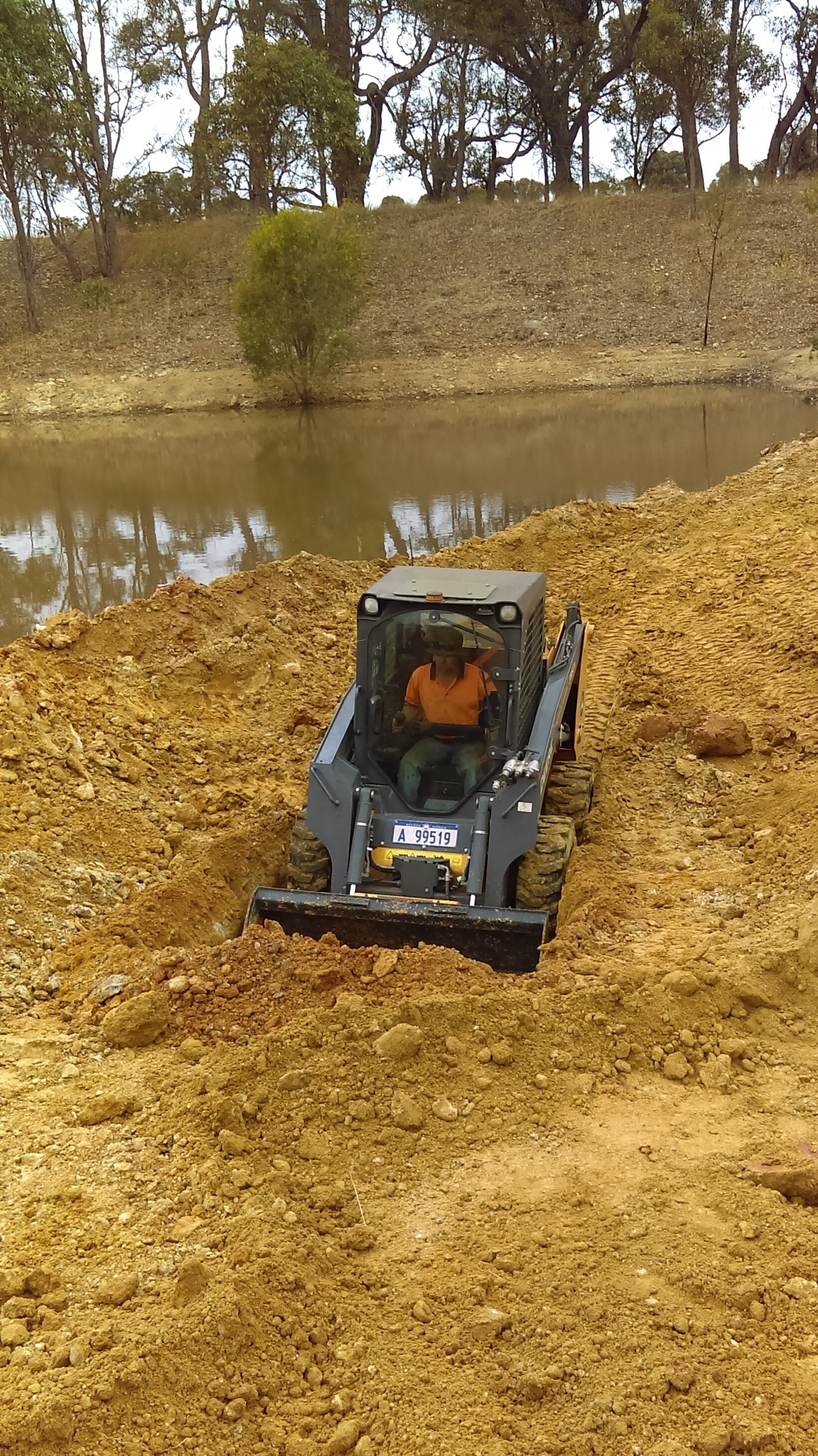 Dam repair work - patching a gravel seam and re-sealing