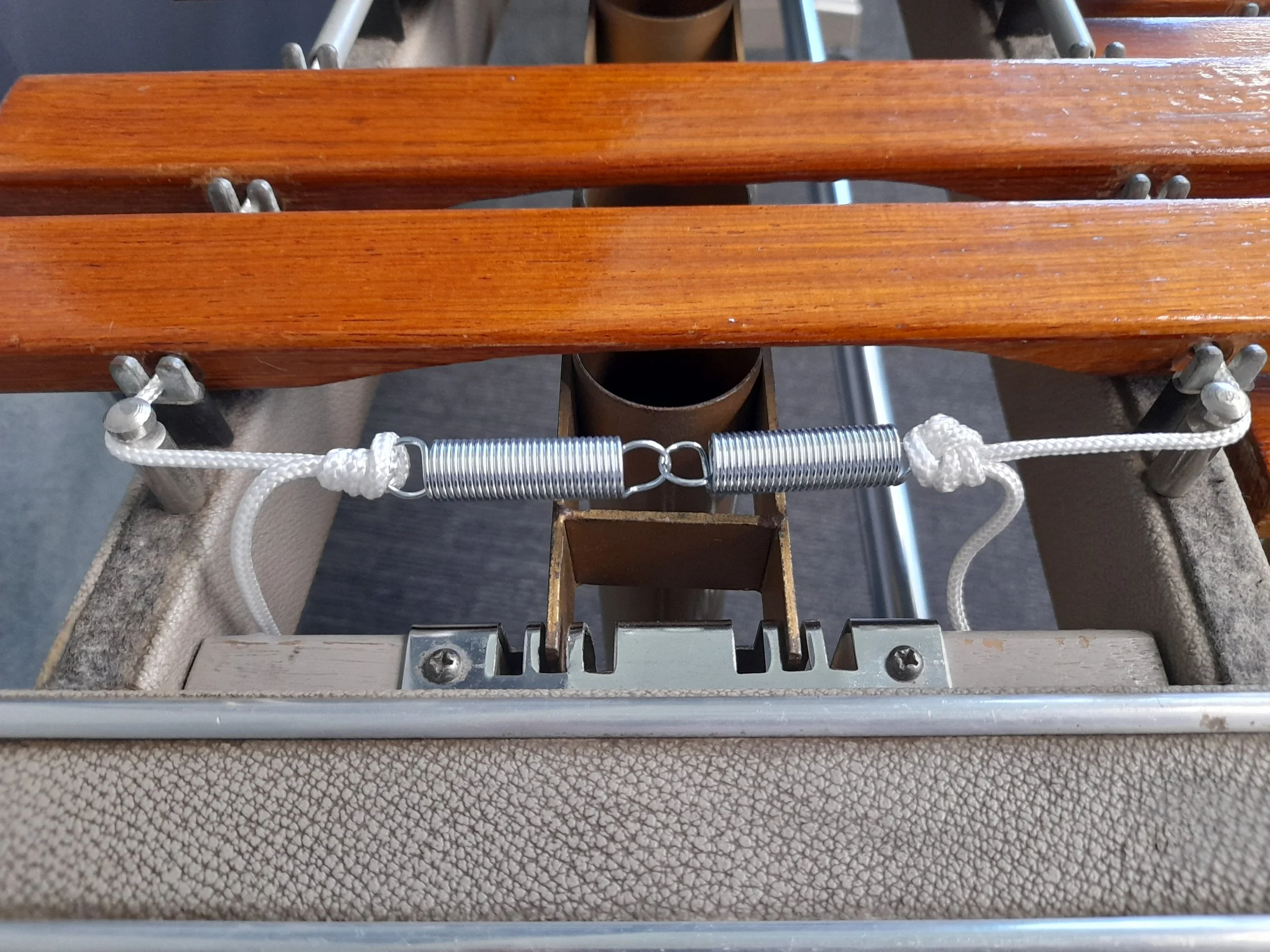 Close-up of xylophone tension springs and cord.