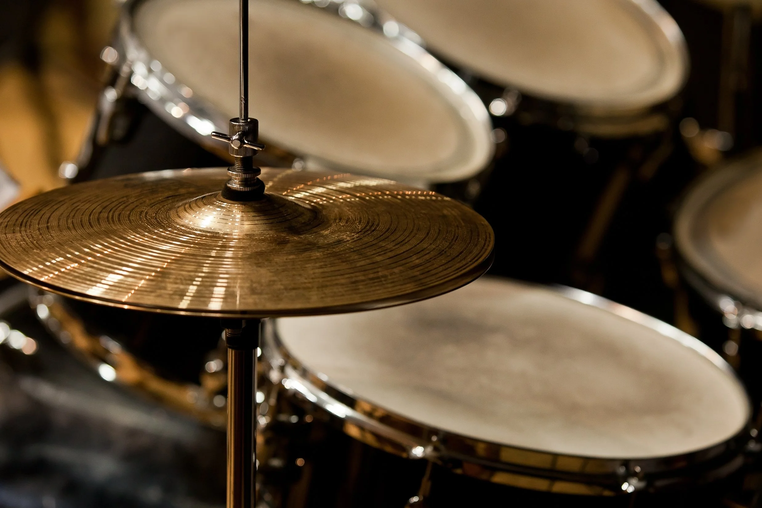 Close-up of a drum kit focusing on the hi-hat cymbals.