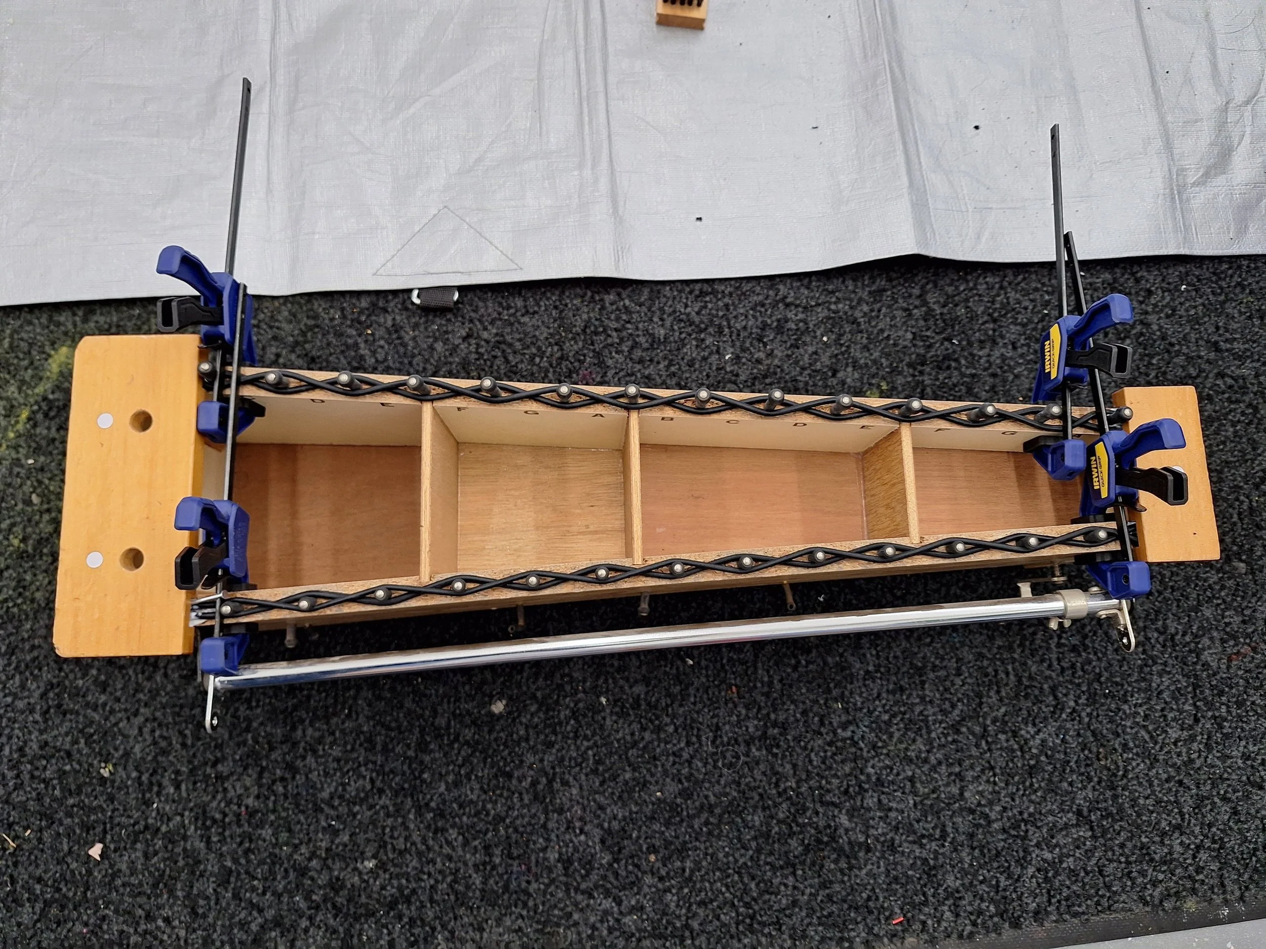 Orff metallophone mid-repairs. The cord has been replaced and pins aligned.