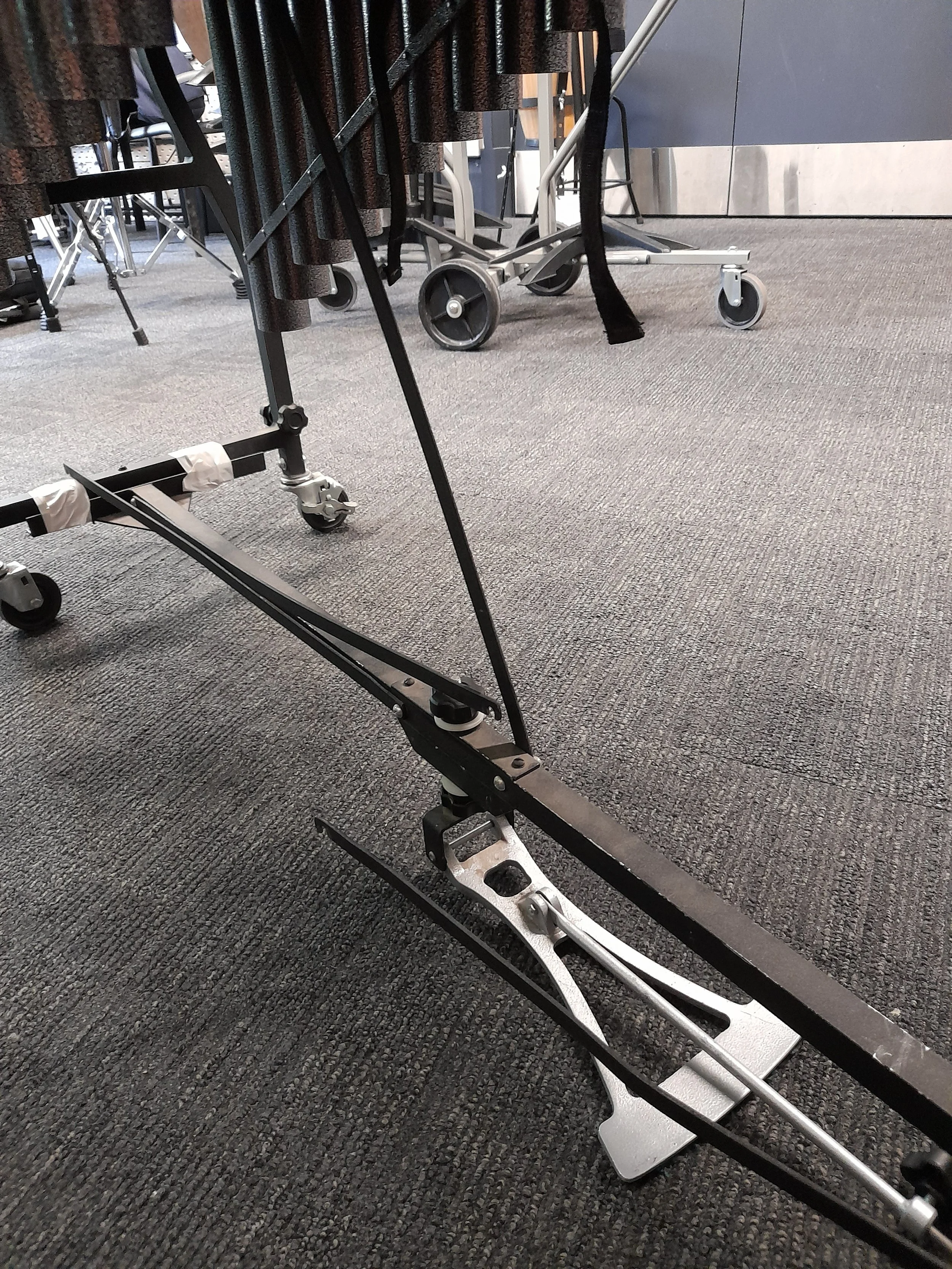 Broken vibraphone with disconnected crossbeams and pedal, supported by duct tape.