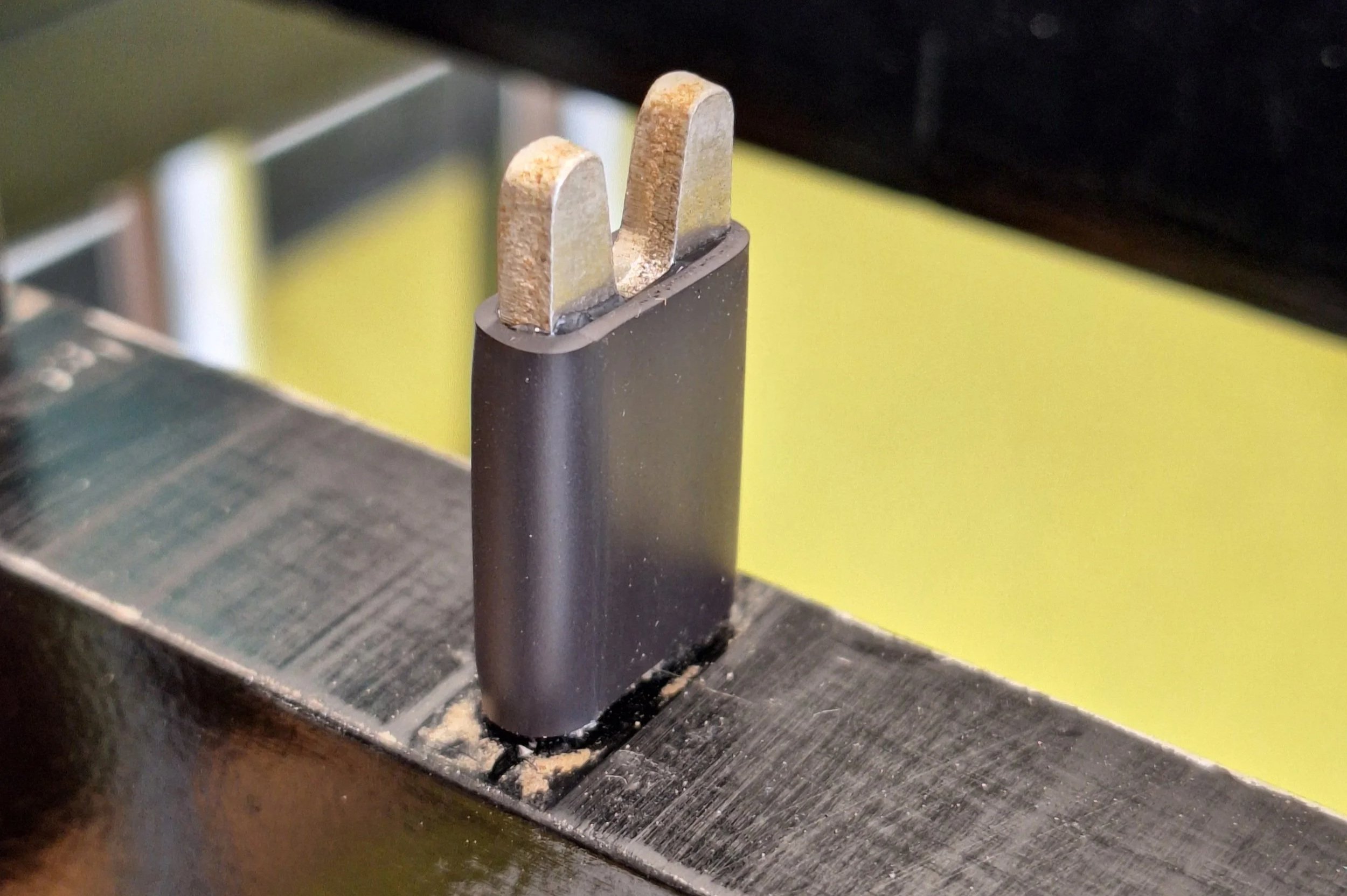Close-up of rubber post-dampener.