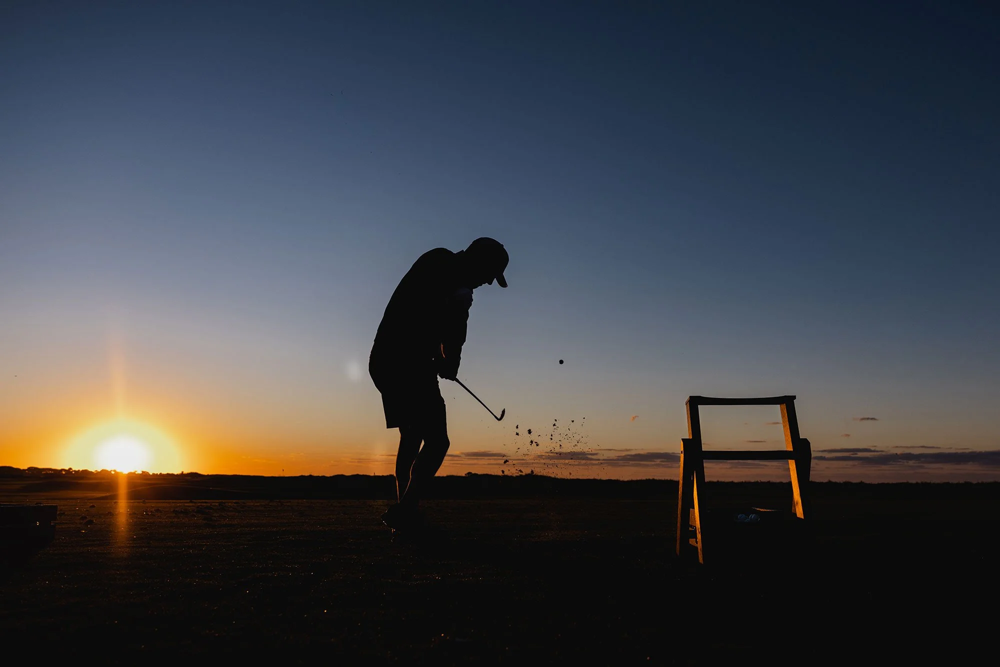 Golfer silhouetted against a low sunset at Kiawah Island