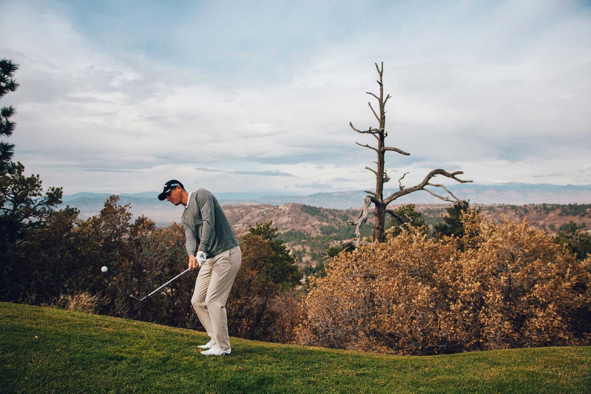 Golfer playing among autumn landscape in Colorado
