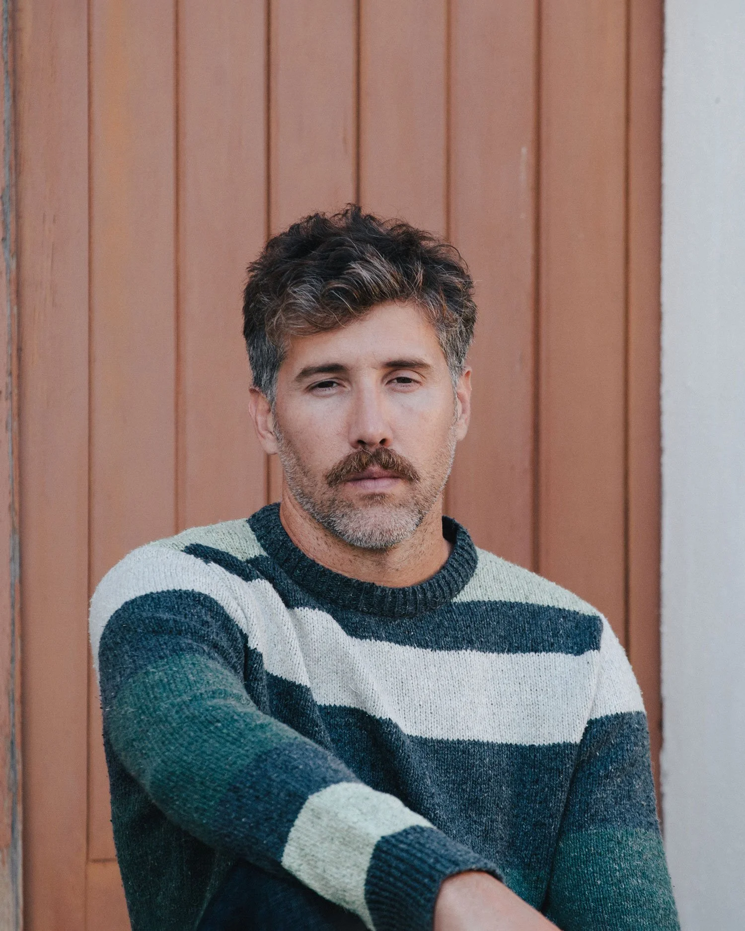 Editorial portrait photographed in Biarritz for TwoThirds by photographer Karl Mackie, capturing slow coastal living and timeless knitwear styling in natural light.