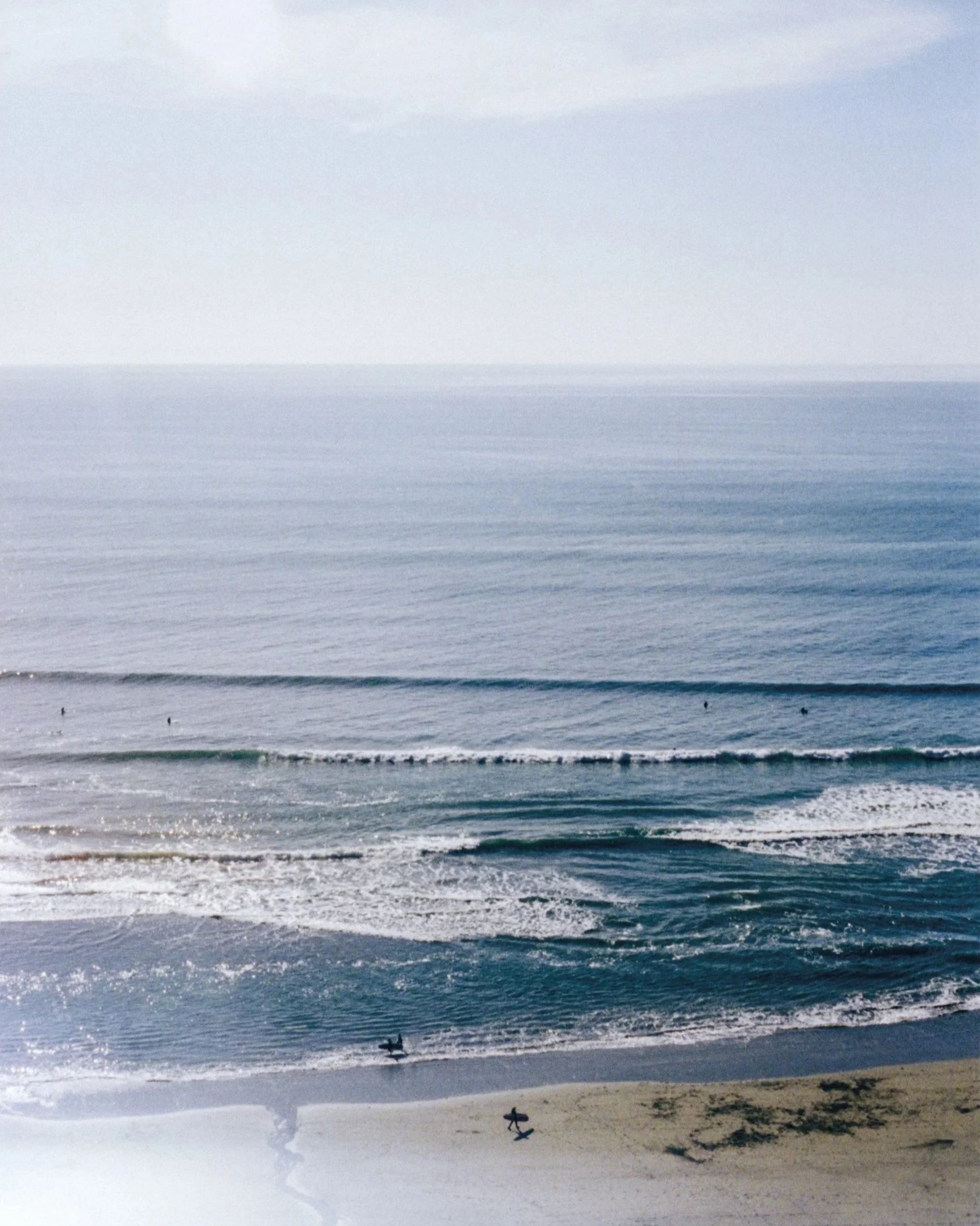 Coastal photography Cornwall, surfers and waves in natural light on 35mm film