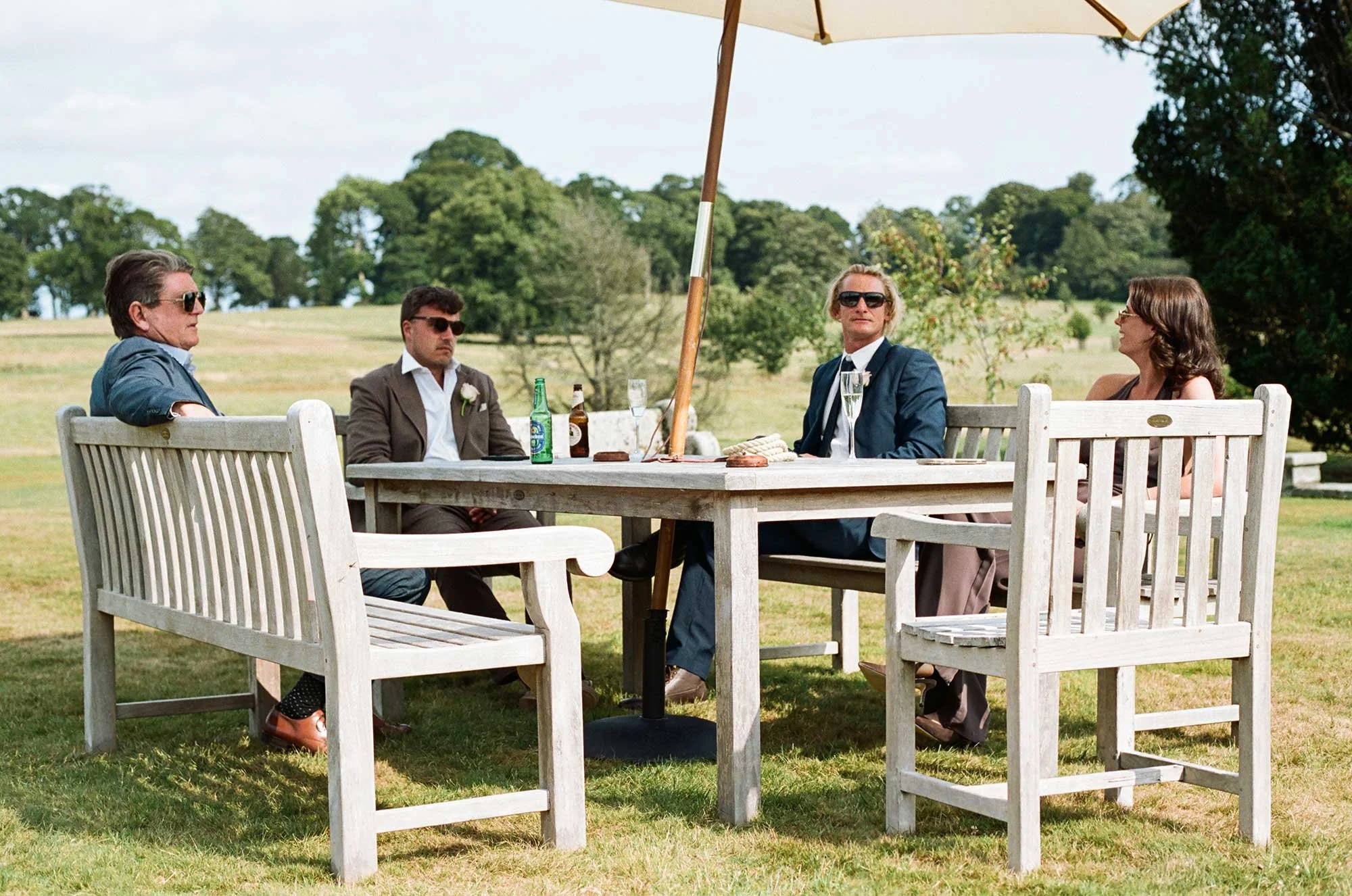 Wedding guests relaxing outdoors during a summer wedding in Cornwall