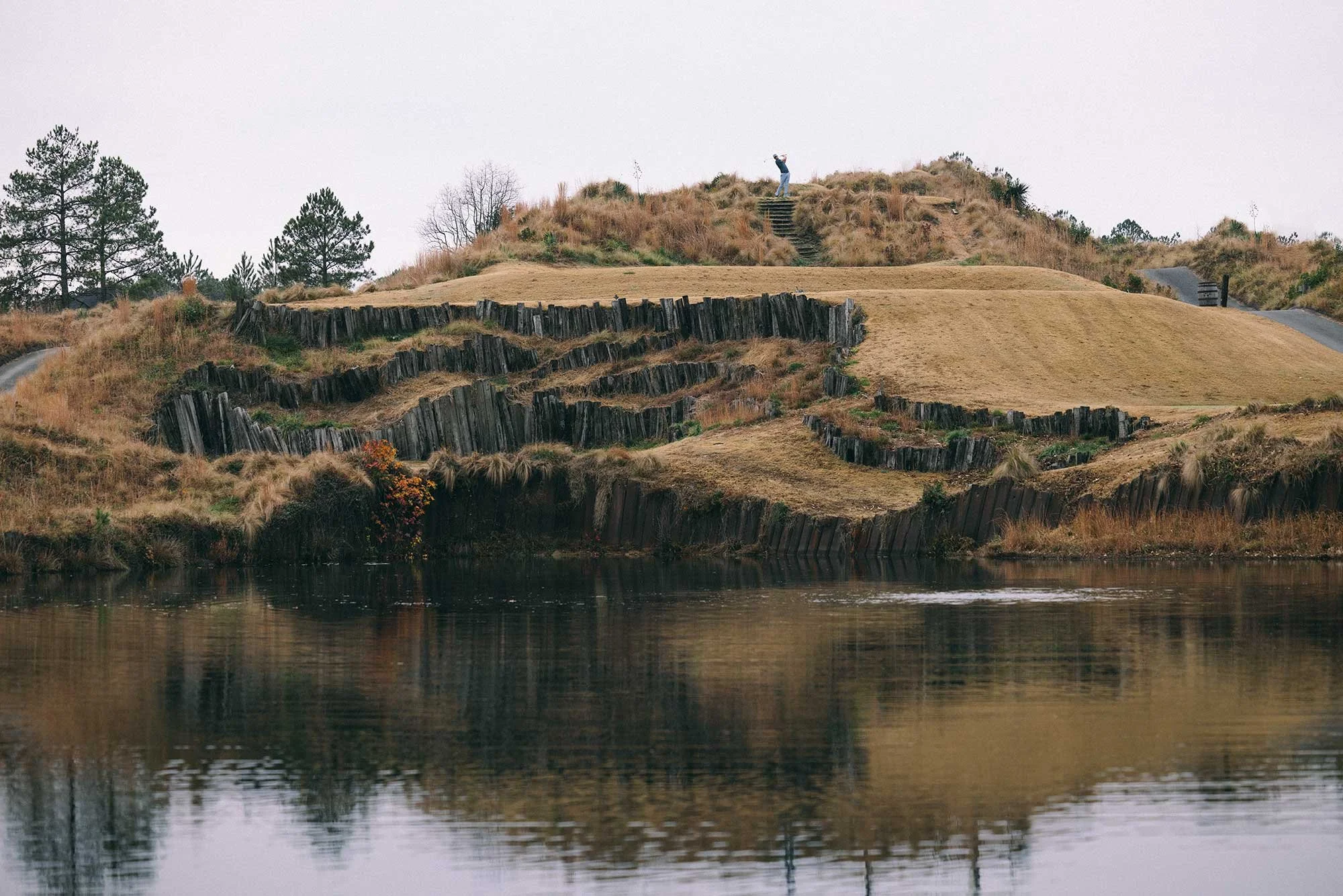 Dramatic golf course landscape reflected in still water
