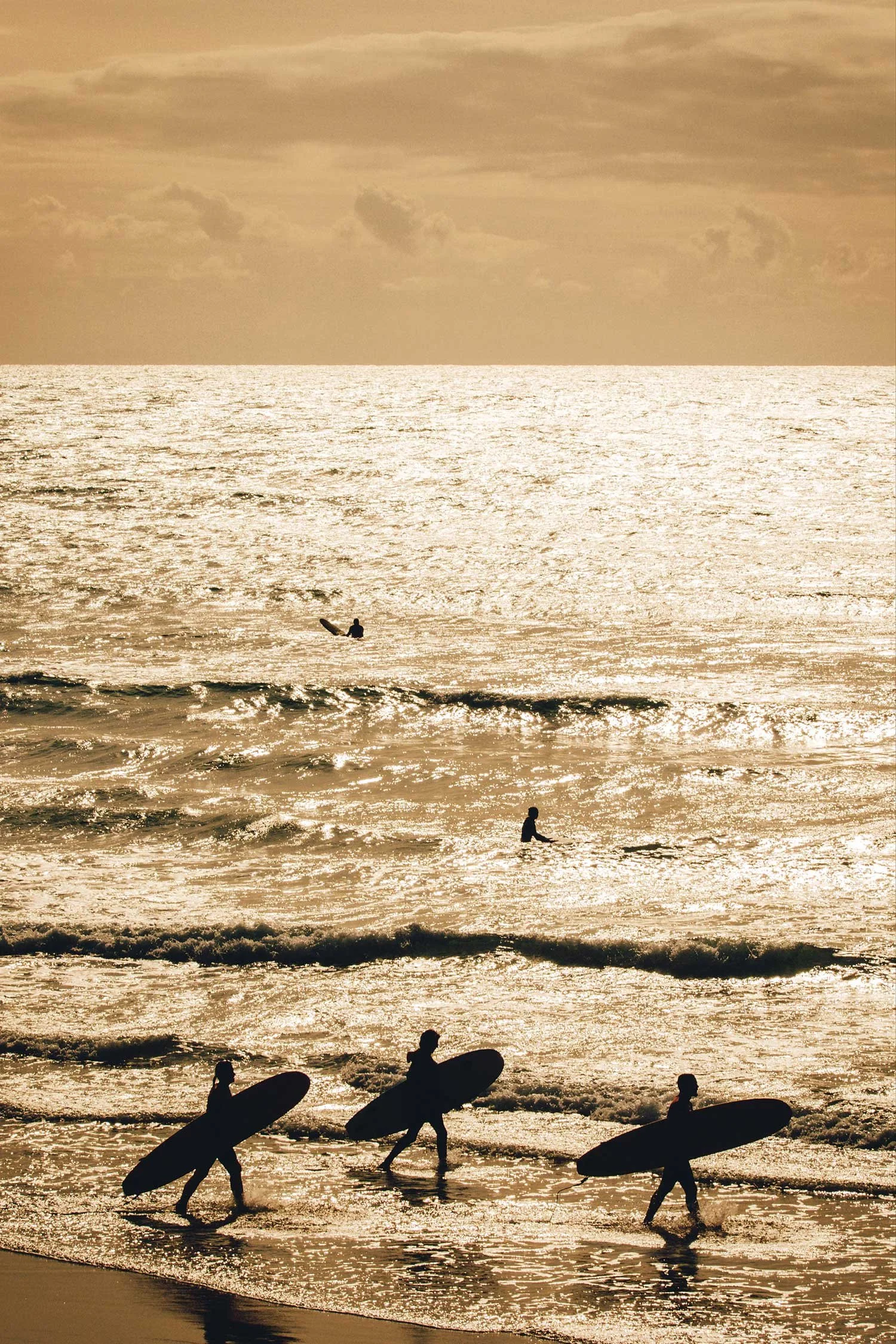 35mm film photograph of surfers walking into the sea at Cote des Basques in Biarritz by Karl Mackie