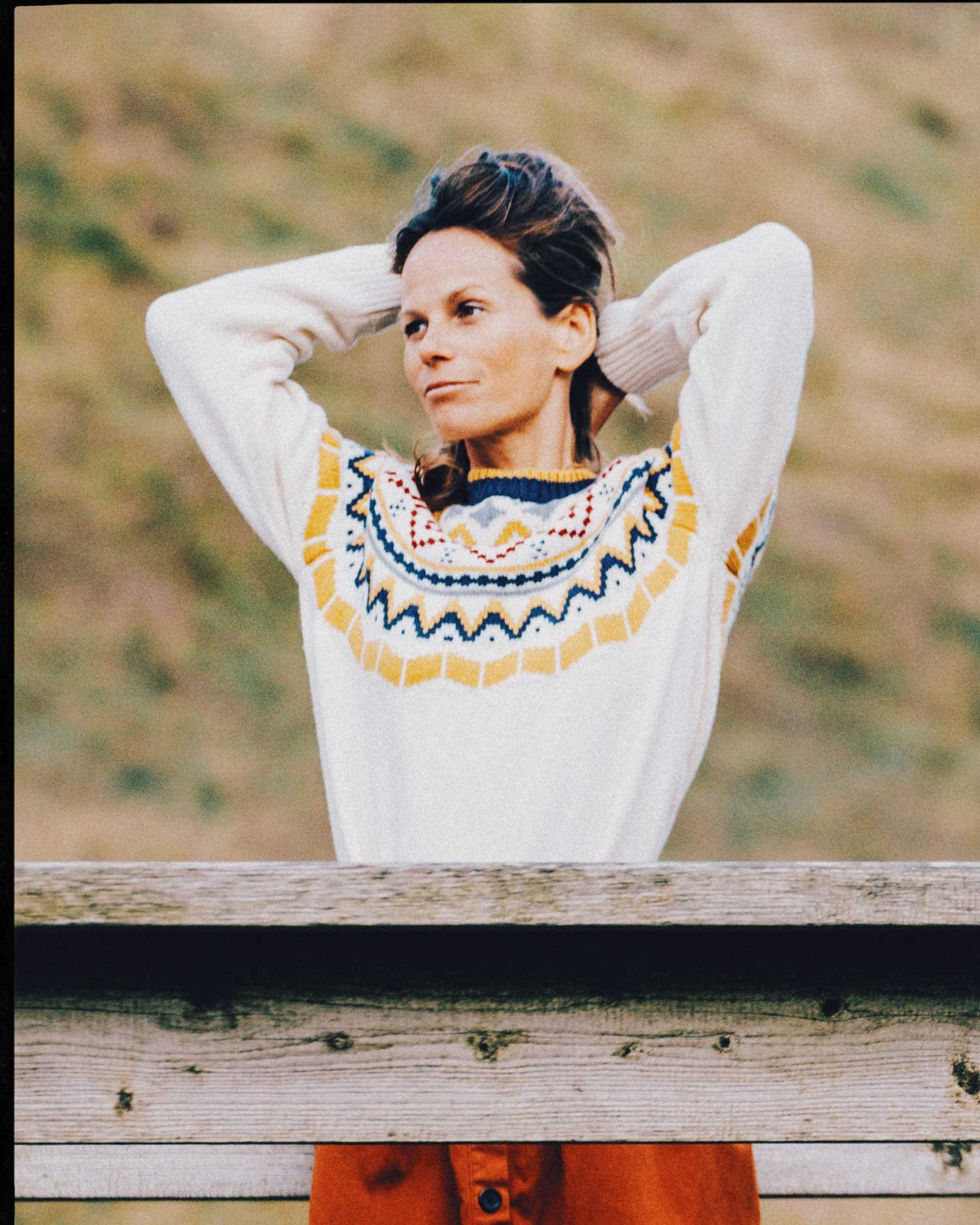 Editorial lifestyle portrait of woman in patterned knitwear outdoors, natural light fashion photography