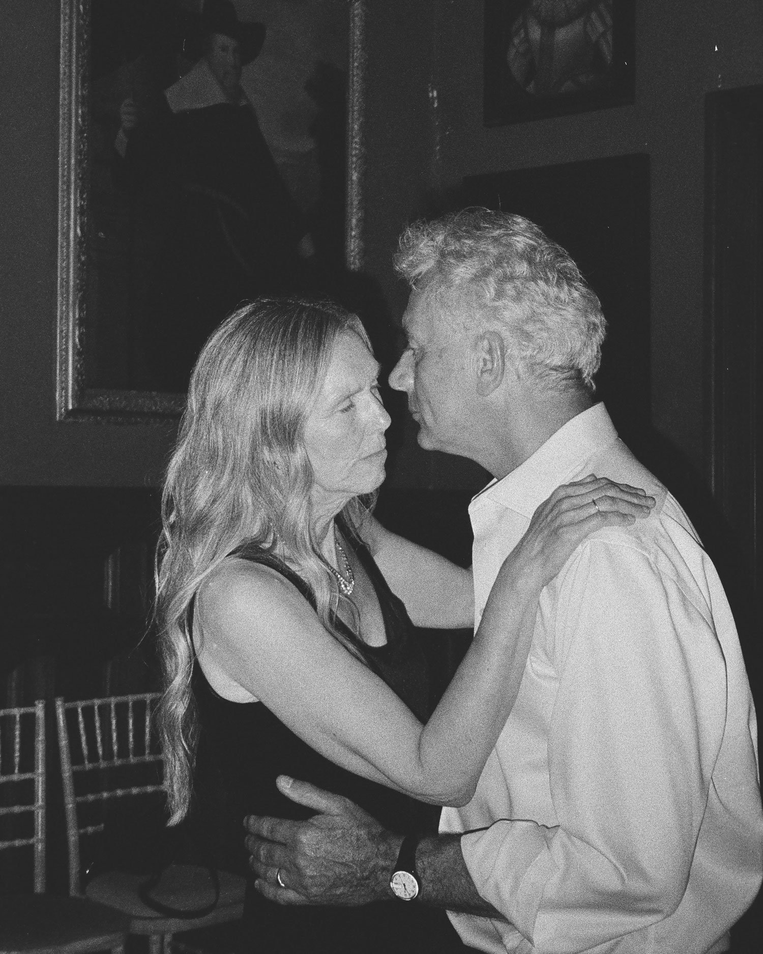 Editorial documentary wedding photograph on film, intimate evening reception moment in black and white