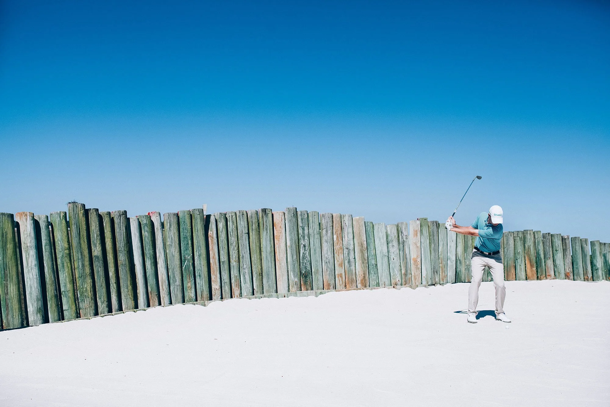 Golfer framed against a vast blue sky on a South Carolina golf course