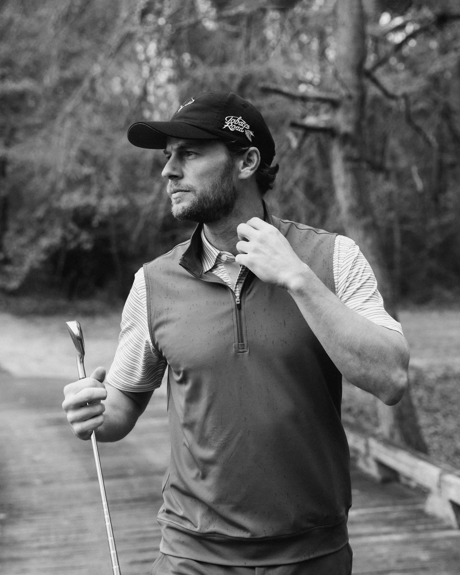 Premium golf apparel brand photography, black and white portrait of male golfer on location