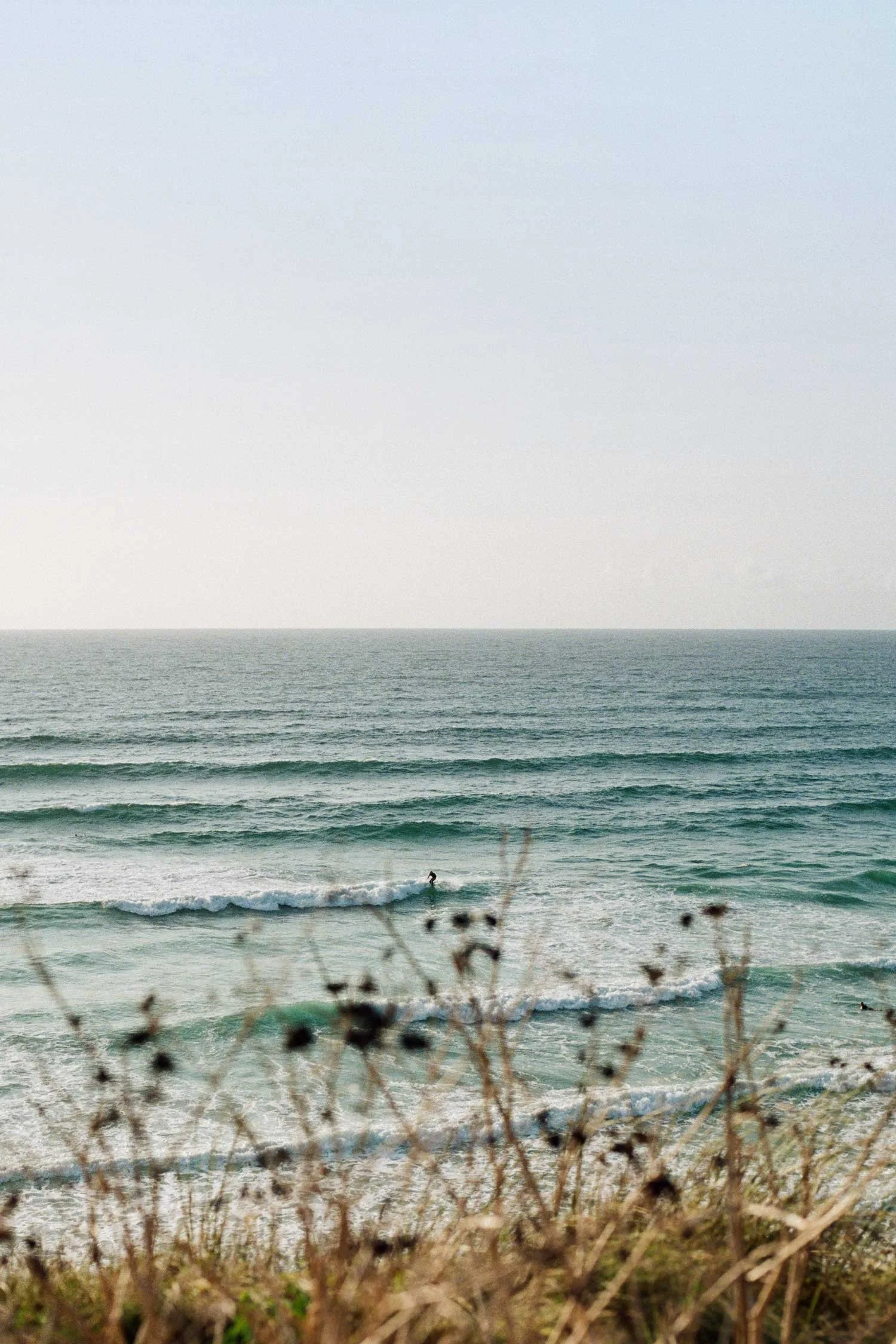 35mm film photograph overlooking surf at Fistral Beach in Cornwall by Karl Mackie